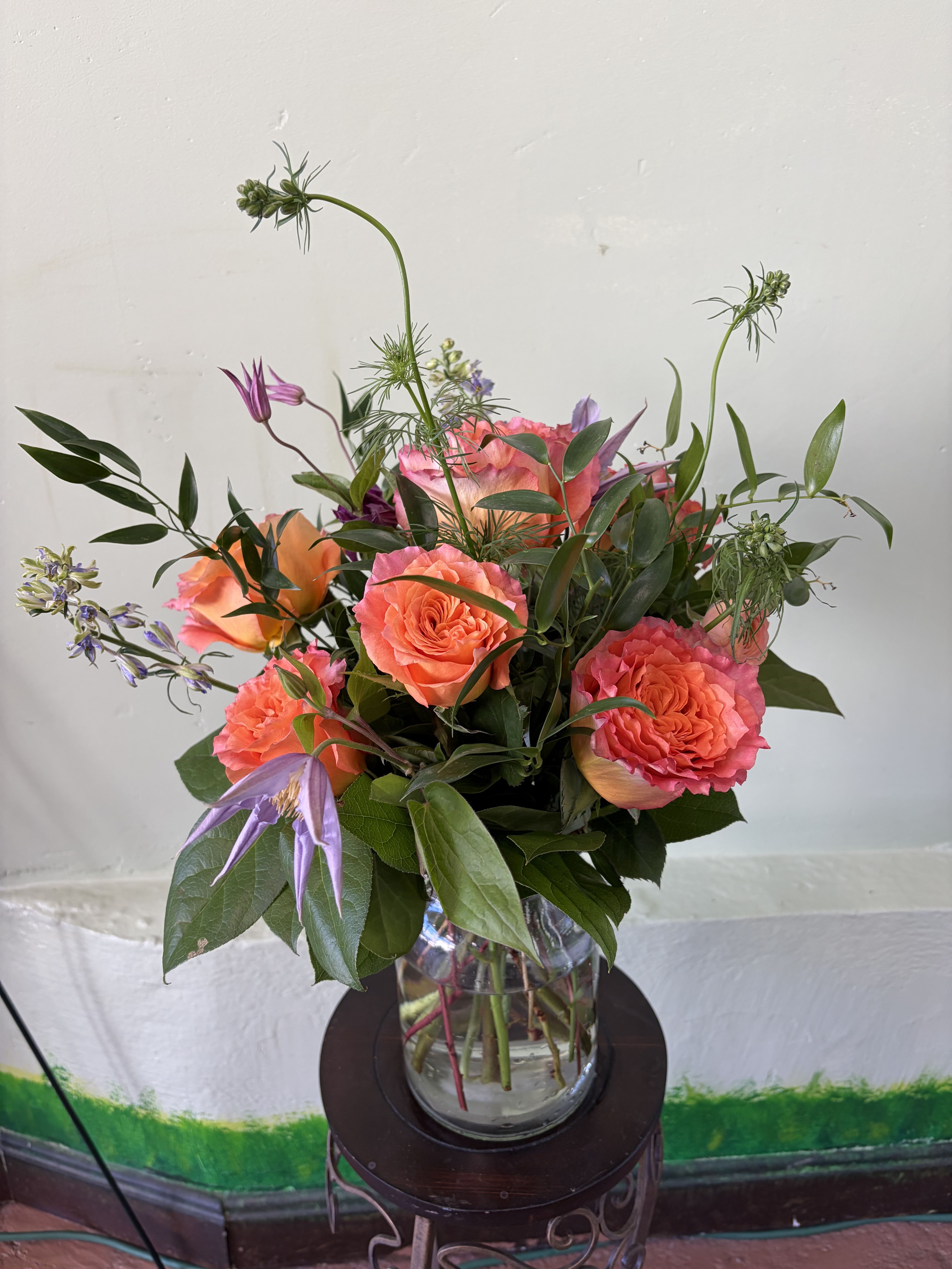 The Breeze Charm - A lively mixed arrangement with soft tones and fresh greenery, perfect for adding a bright and graceful touch to any setting.