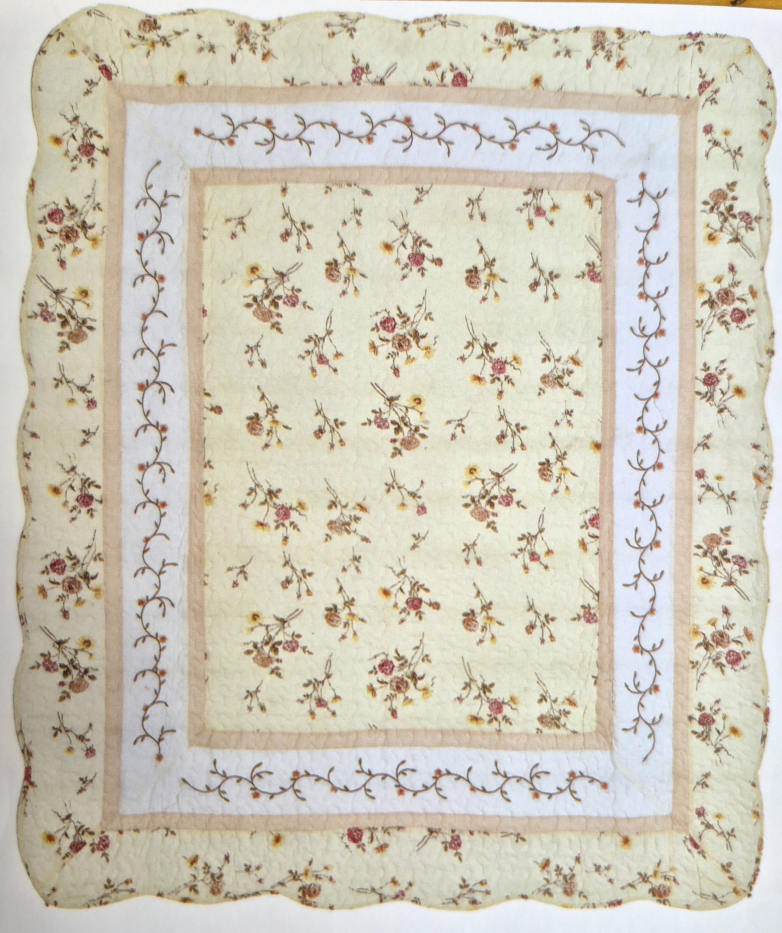 Mauve Rose Vine Quilt  - This throw takes you to times of comfort, family and home. Mauve and White Rose Quilted Throw with scalloped edging. Beautiful throw for Sympathy, Just Because or Birthday. If you would like to send to a home or service of a loved one and need only the quilt. We place a bow on the quilt and fold for presentation.  If you would like to send to a home or service of a loved one and need only the quilt. We place a bow on the quilt and fold for presentation. 50 x 60 Easel is 15.00 extra, Choose Deluxe to add easel to order for presentation.