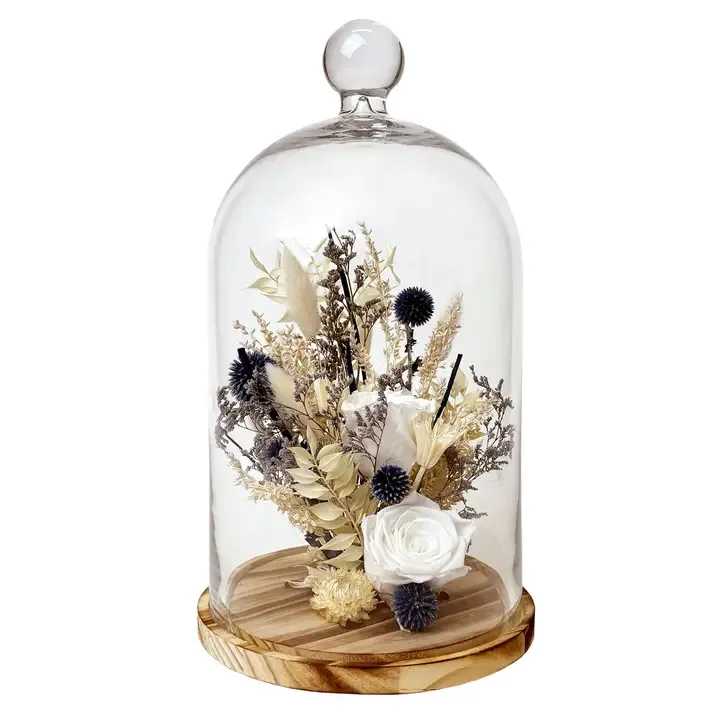 15" White Preserved Rose &amp; Echinops Botanical Cloche - Description A preserved real rose is arranged among a mix of natural botanicals like echinops, bunny tails, and caspia in this stunning floral arrangement placed in a large glass cloche on a wooden pedestal base.  This centerpiece is full of natural textures and neutral colors that easily accentuate any home and are sure to be a show stopper!