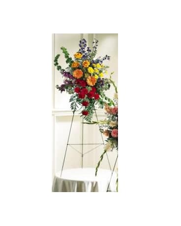Fond Farewell - Share their grief with this distinctive display. The colorful arrangement includes orange gerbera daisies red carnations yellow roses blue belladonna delphinium and more. Delivered with an easel.   FCS11-3444