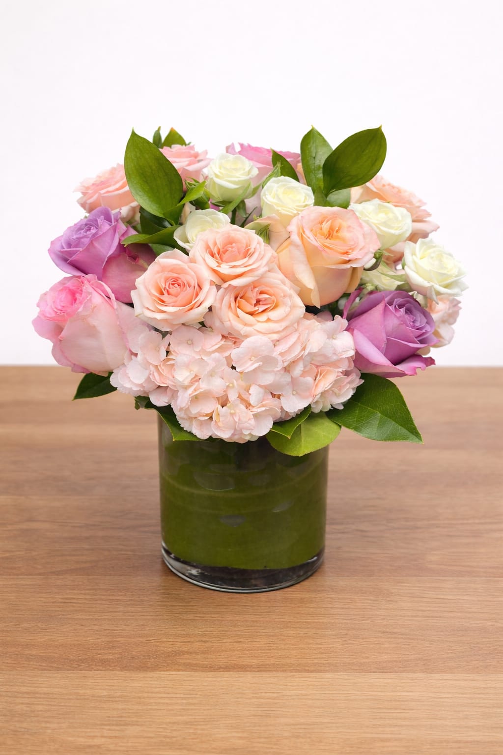 Blush and Bloom - Blush &amp; Bloom is a romantic Valentine’s Day arrangement featuring a lush mix of blush, peach, pink, and ivory roses paired with soft hydrangea and seasonal greenery. Designed in our signature modern style, this bouquet is perfect for celebrating love, anniversaries, or meaningful moments.  Elegant, timeless, and effortlessly romantic, Blush &amp; Bloom makes a beautiful statement for Valentine’s Day or any occasion that calls for something special.