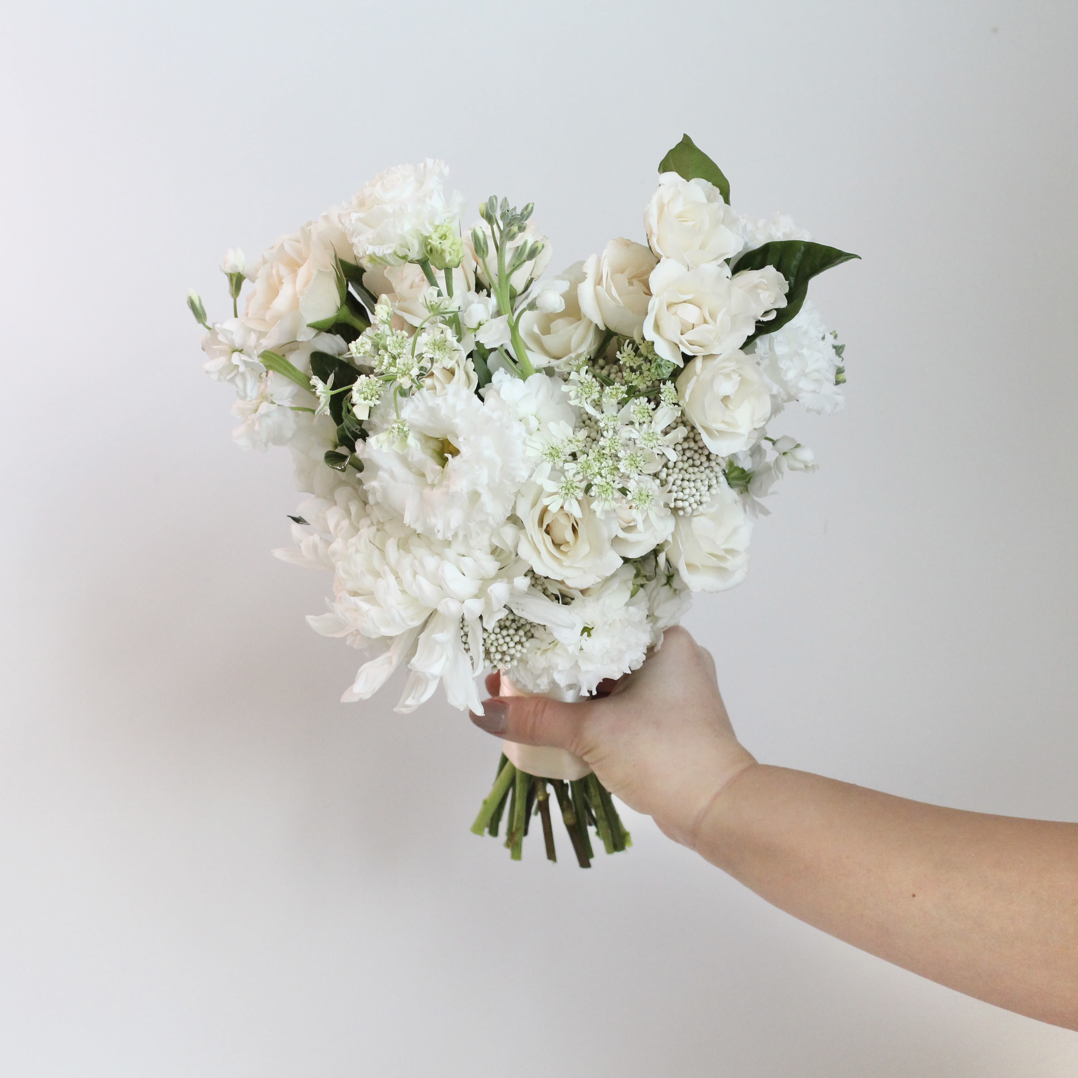 White &amp; Green Neutral Petite Bouquet - Elevate your celebration with the beauty of coordinated sophistication with Middlemist's A la Carte Events! This thoughtfully curated collection features products in harmonized color palettes. Select one to bring style and cohesion to your special occasion. With a minimum purchase of $300, create a polished look, knowing every piece complements the other perfectly.   Walk down the aisle with natural elegance! Our Green &amp; White Petite Bridesmaid Bouquet features a timeless blend of lush greenery and crisp ivory blooms, creating a fresh and sophisticated accent for your special day.  The Details:  -Please allow at least 2 weeks notice so we can source the freshest, most beautiful blooms for your arrangements. -Custom requests are not available for À La Carte orders. If you have specific ideas, please check out our Custom Event page or contact us directly. --Changes or additions to your order must be made no later than 7 days prior to the pick-up date. --Enjoy free pick-up at our studio Monday through Friday. Weekend pick-ups are available for an additional $200 and must be scheduled by appointment.  **Cancelation Policy: Orders canceled within the 2-week window are non-refundable. Refunds are available only for cancellations made 3+ weeks before the event date.  We’re here to make your event feel as special and unforgettable as possible—just leave the floral magic to us!