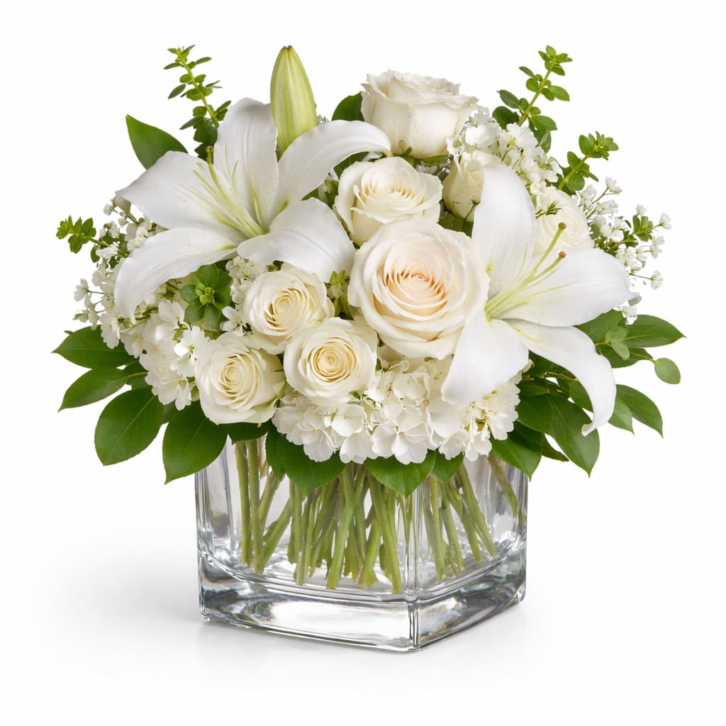 Shining White  - Beautiful flowers such as white hydrangea, spray roses and stock, peach roses, eucalyptus and more fill a tall glass vase.  *Vase/container may vary depending on availability of stock at time of purchase. *We strive to use the flowers shown whenever possible; however, substitutions of equal or greater value may be made based on seasonal and market availability.  