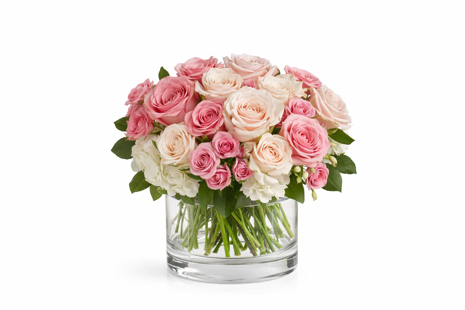 Rosewater Garden - This gorgeous bouquet includes white hydrangea, light pink roses, pink roses, crÃ¨me roses, pink spray roses fillers and greens.  *Vase/container may vary depending on availability of stock at time of purchase. *We strive to use the flowers shown whenever possible; however, substitutions of equal or greater value may be made based on seasonal and market availability.   