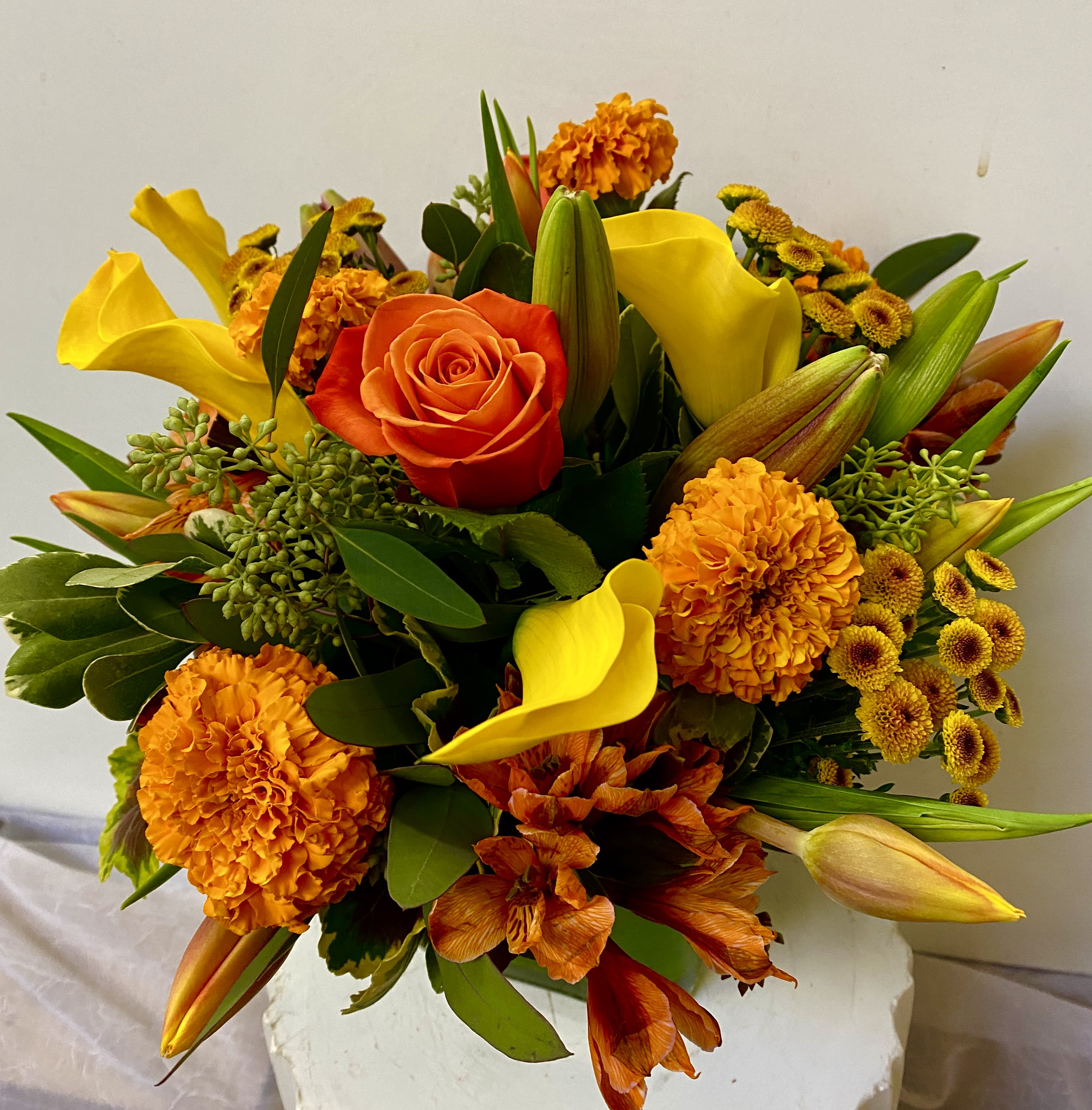 Homes for the Holidys - orange flowers in a glass vase