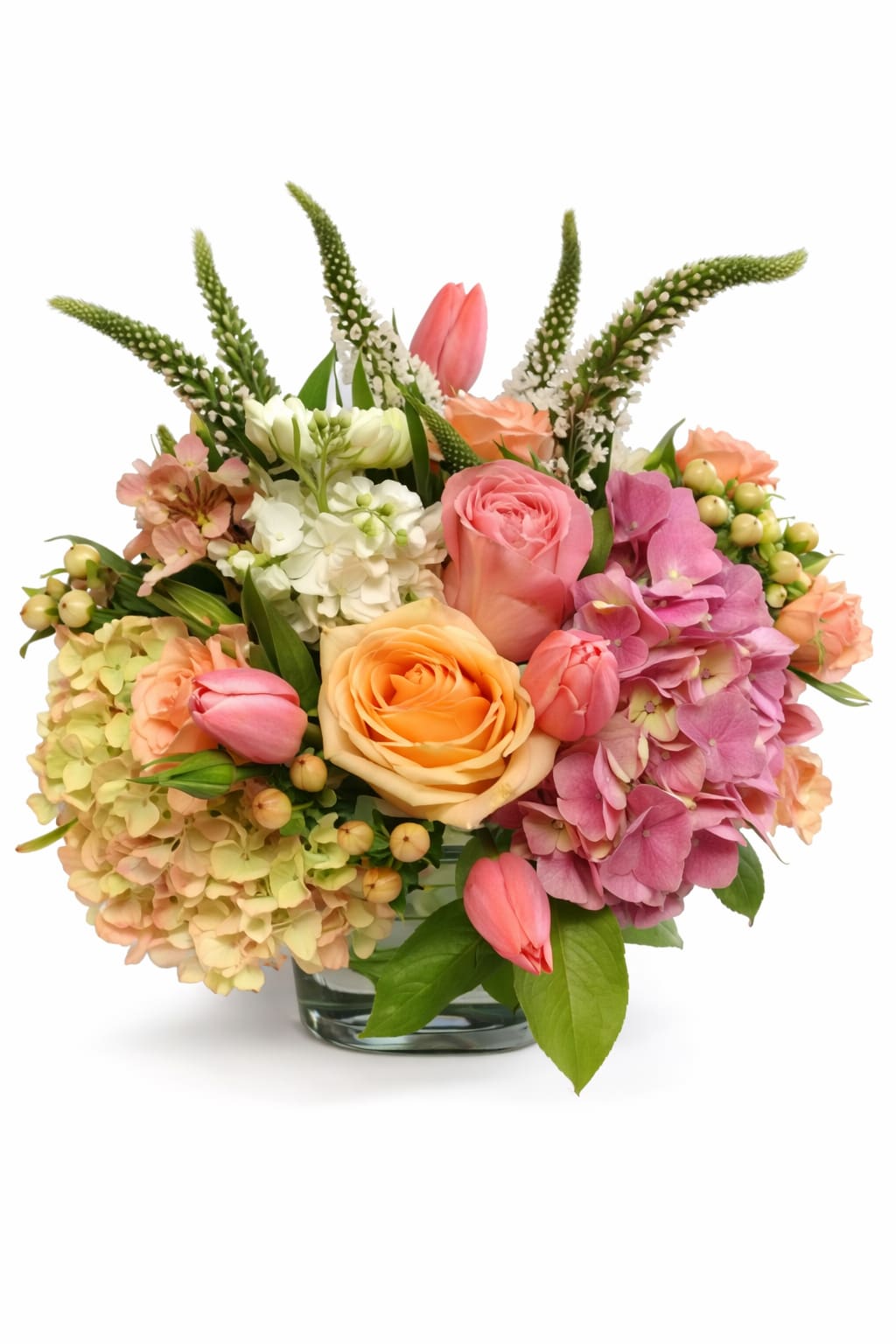 Pink and pretty. - This low centerpiece is complete with peach roses, tulips, snap dragon, stock, hydrangeas, hypericum, spray roses and various greenery.  (Some flowers may be subject to change depending on the season.  We will contact you with available flower substitutions; please contact us with specific questions if you are concerned with flower availability, thanks!)  Featured arrangement: $135.75 [Regular Price)