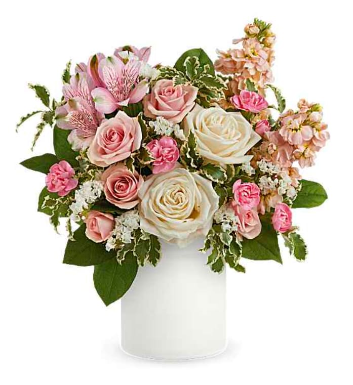 Pastel Party Bouquet - Make her feel like the princess she is with this perfect pastel rose bouquet, gathered in a charming frosted glass jar with chic matte finish. Crème roses, pink spray roses, pink alstroemeria, miniature pink carnations, pink stock and white sinuata statice are arranged with pitta negra and lemon leaf. Delivered in Teleflora's Savannah Jar. Orientation: All-Around