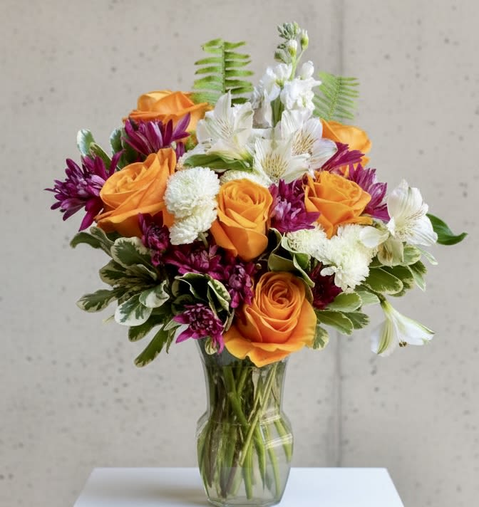 ORANGE CRUSH - Perfect blend of roses and complimentary florals and greenery artistically put together in a free form style.  