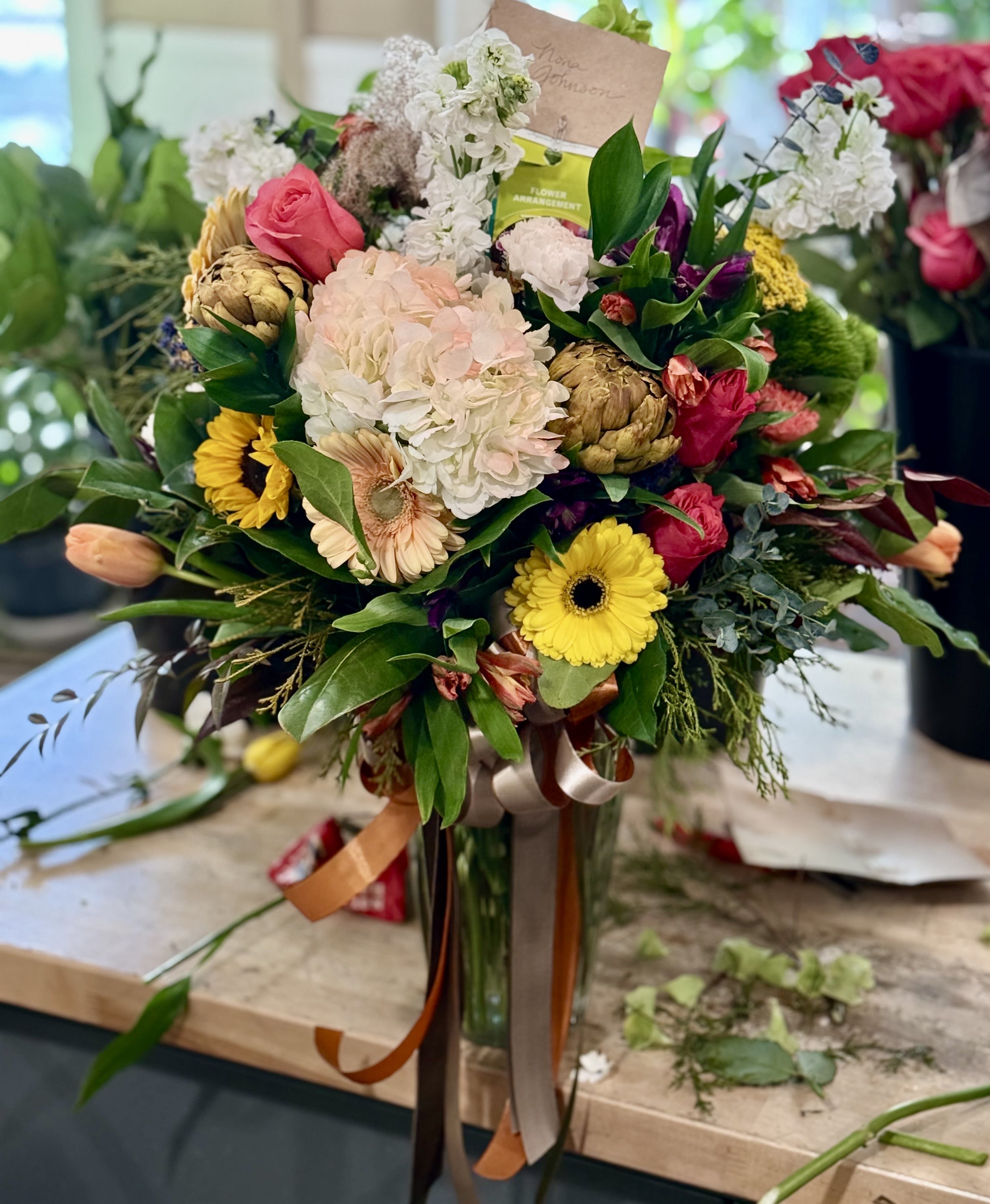 Grandeur Bright Display  - Celebrate with a large lush display of hydrangeas, roses, alstroemeria, stock and many other premium flowers. 