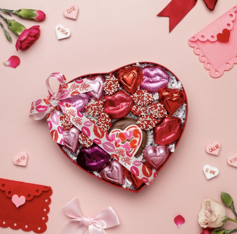 Kisses Assorted Chocolates - Enjou Chocolat of New Jersey  Impress the most serious chocolate lover this heart box of chocolate kisses and nonpareils.  Filled with festive red and white nonpareils, foiled hearts and lips, and a chocolate covered Oreo topped with a painted sugar "Love Me" message, this box presents a lovely mix of milk chocolate.