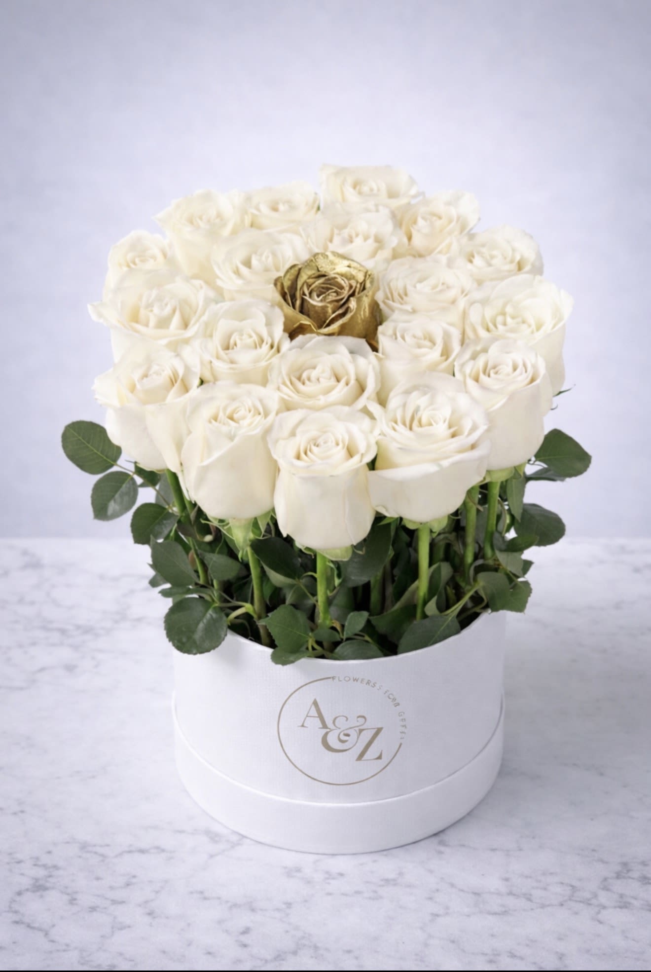 Pure Grace with Gold  - Elegant ivory roses crowned with a touch of gold - where softness meets luxury.