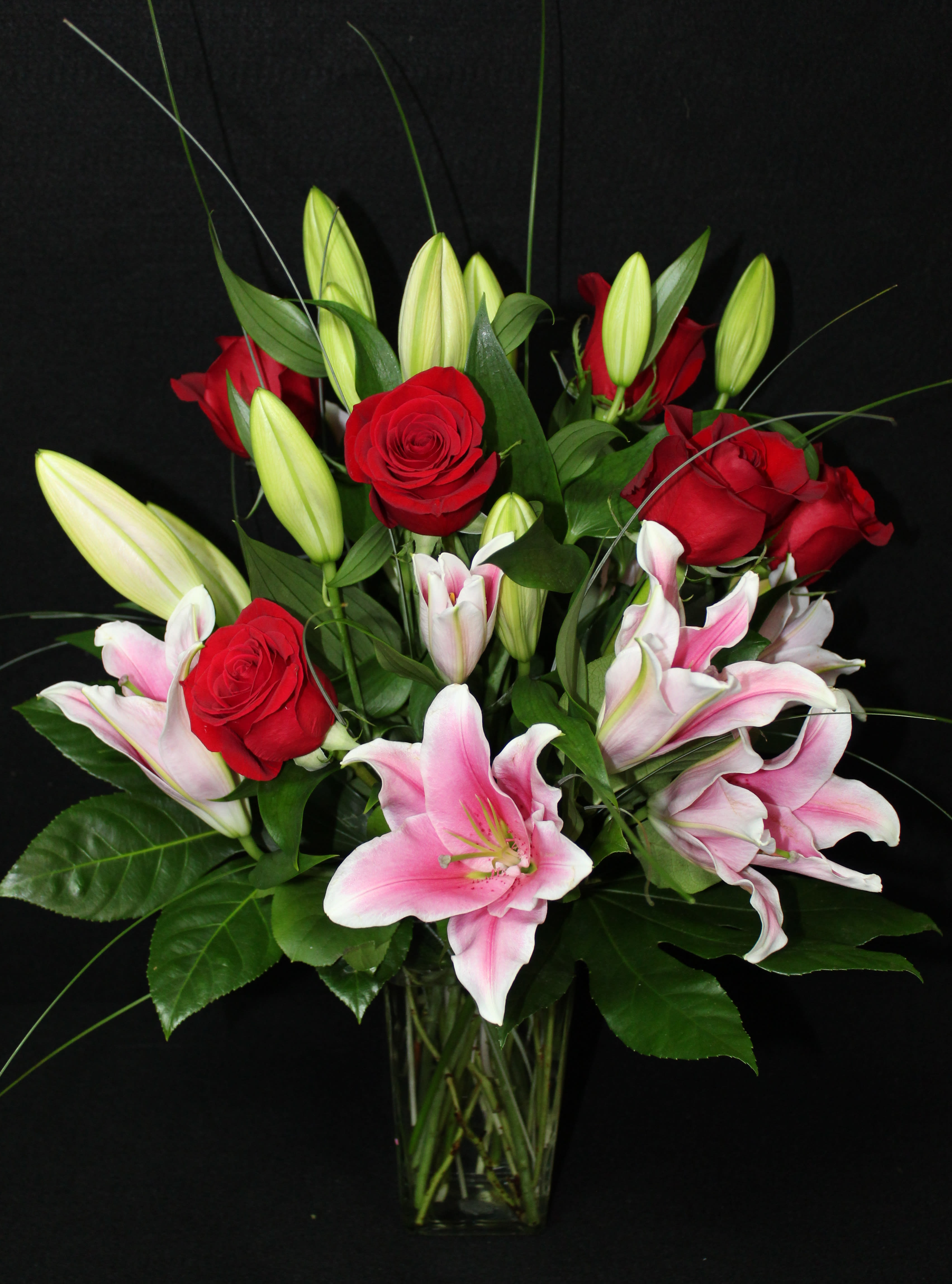 Classic Romance - A classic bouquet of red roses and stargazer lilies is the perfect gift for that special person.