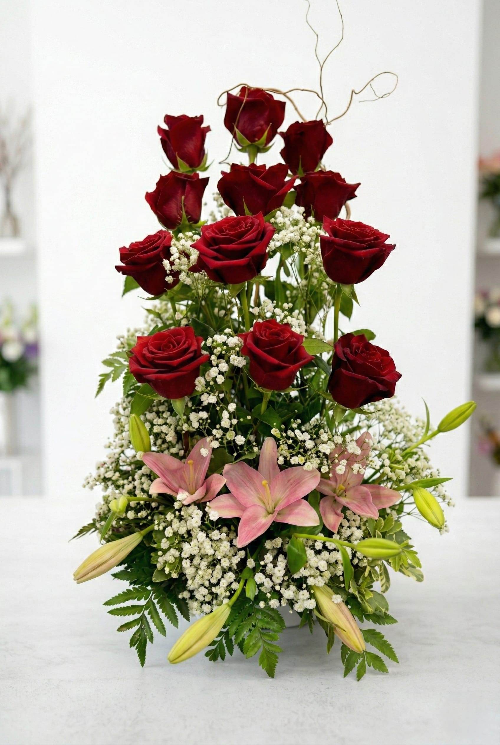 Love Duet - A Beautiful duet of our Dozen Long Stem Red Roses and elegant Lilies arranged to make a lasting impression. Perfect for any occasion. 