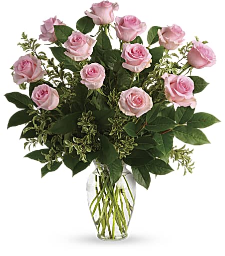 Dozen Pink Roses (BR) - This exquisite flower arrangement showcases the timeless beauty of 12 long stem pink roses, expertly arranged in a clear glass vase. The delicate petals and graceful form of these long stem roses create a stunning display that is both romantic and elegant.