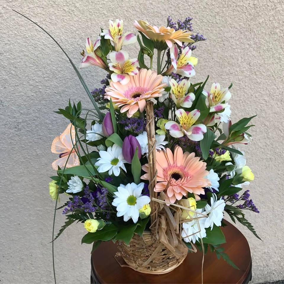 Mixed bouquet with gerbera daisies, daisies, and alstroemeria in a basket