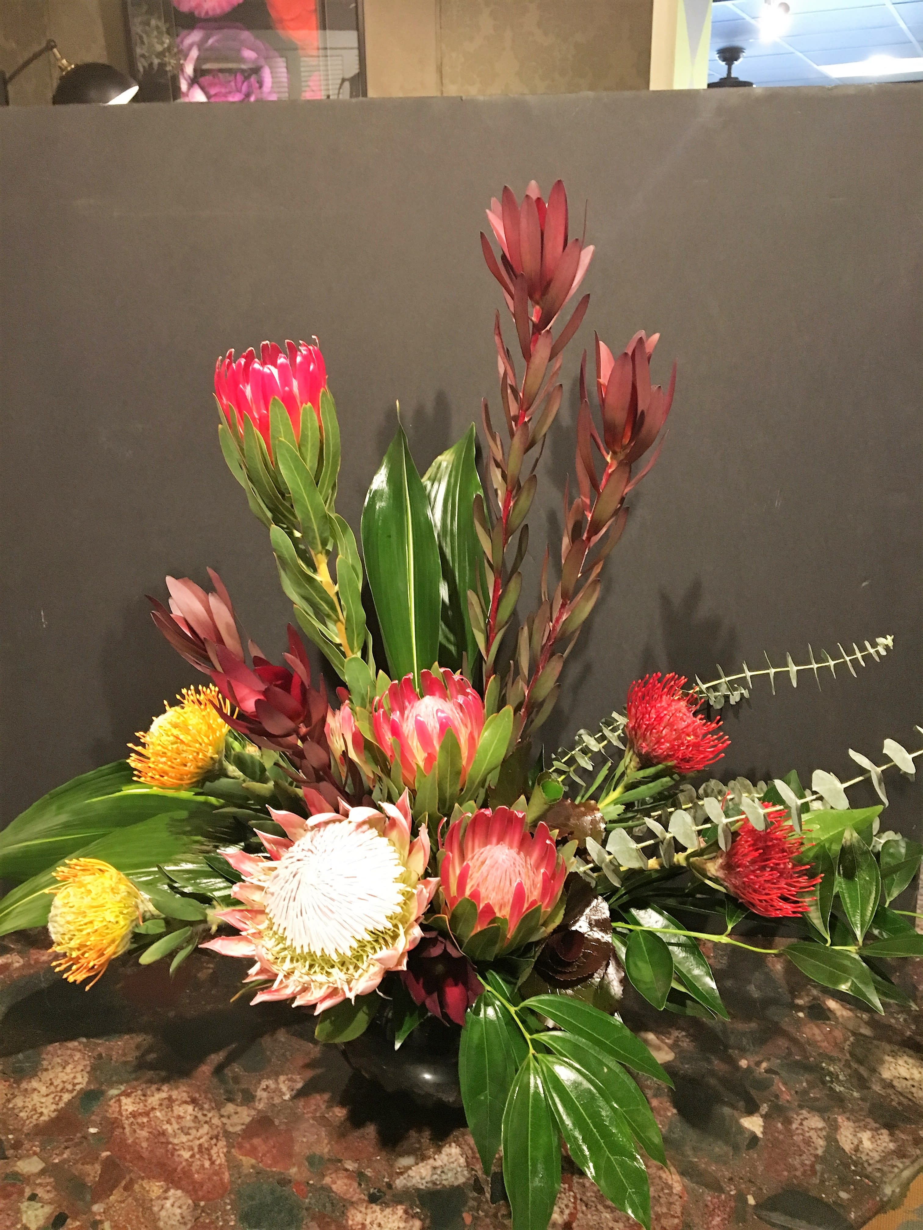 exotic memorial tribute - Exotic foliage accent tropical blossoms. This design requires special order flowers and may not always be available on short notice.  