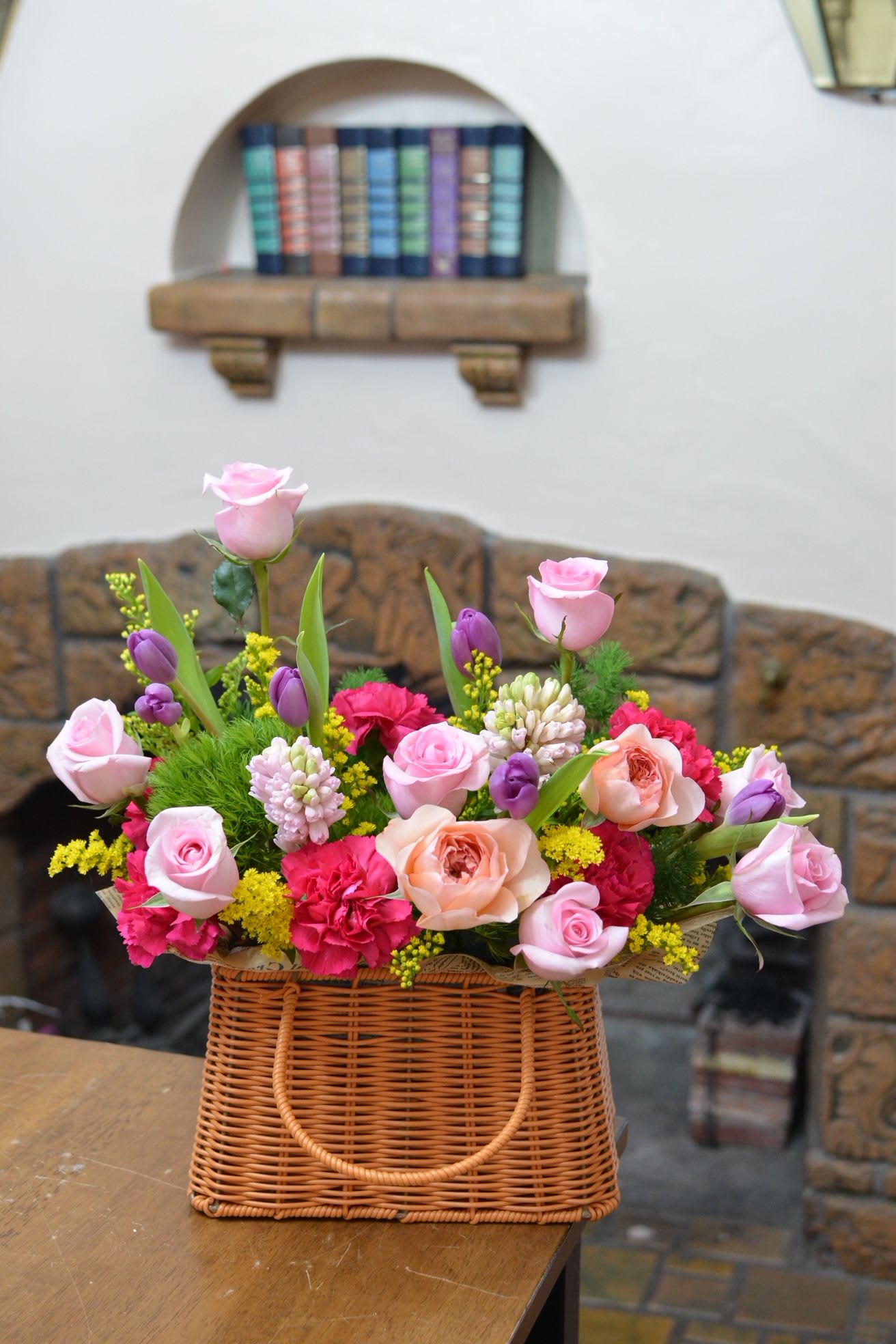 Spring Garden Tote - A couture-inspired floral handbag arrangement featuring sculpted tulips, premium roses, and fragrant hyacinths, artfully designed in a structured purse-style basket. Soft spring textures meet modern elegance, creating a statement piece that feels both fresh and fashion-forward.  Perfect for:  Luxury gifting  Spring soirées  Mother’s Day collections  Boutique signature pieces