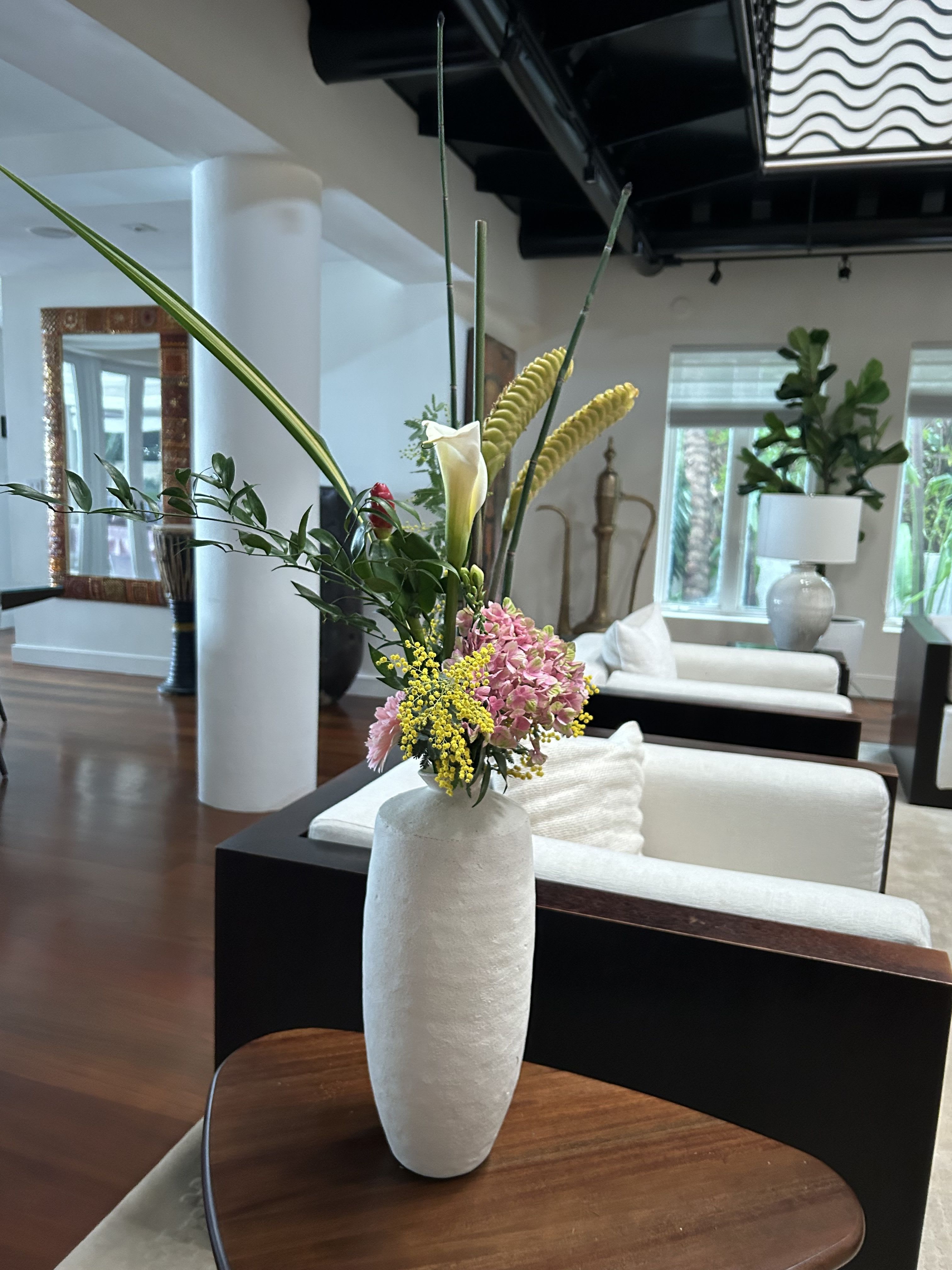 Tropical Poetry - Tall and gorgeous, this centerpiece beauty combines tropical florals, callas, and fun unique blooms for a wow like effect
