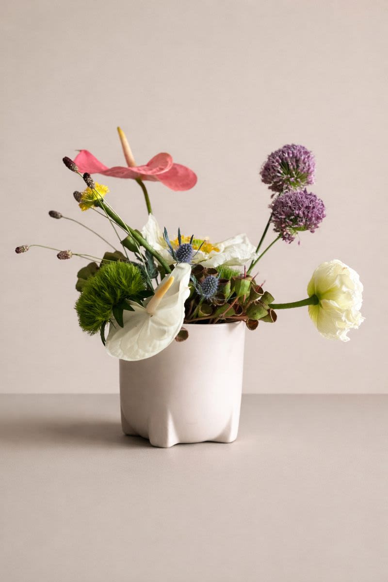 The Cheeky Poppy - Poppies, anthuriums and alliums create a magical little world inside this lovely unique ceramic vessel