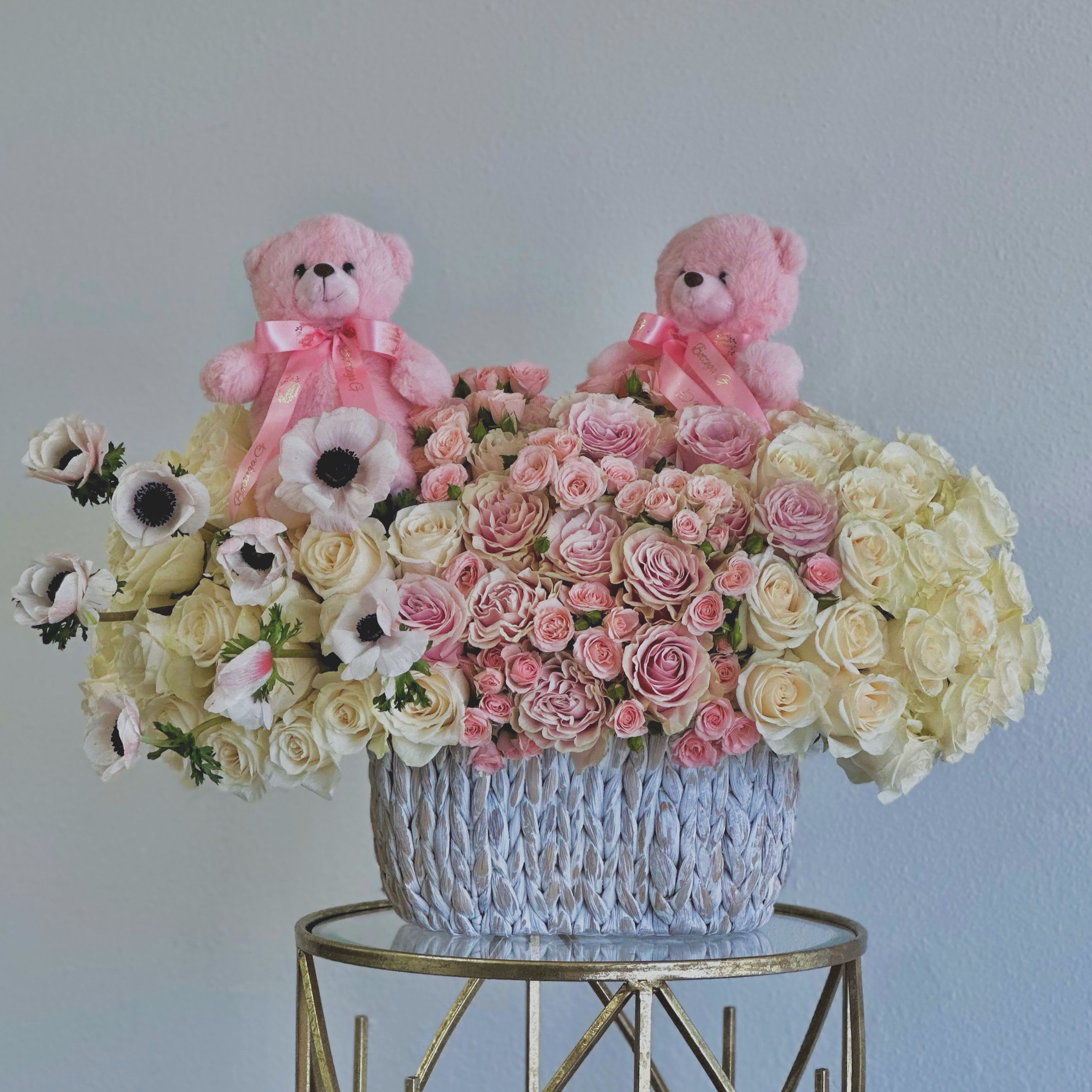 Baby Girl Bliss - Celebrate the arrival of a precious little girl with our charming Welcome Baby Girl Flower Arrangement. This delightful bouquet features a lovely mix of soft pink and white roses, beautifully complemented by two adorable pink teddy bears.