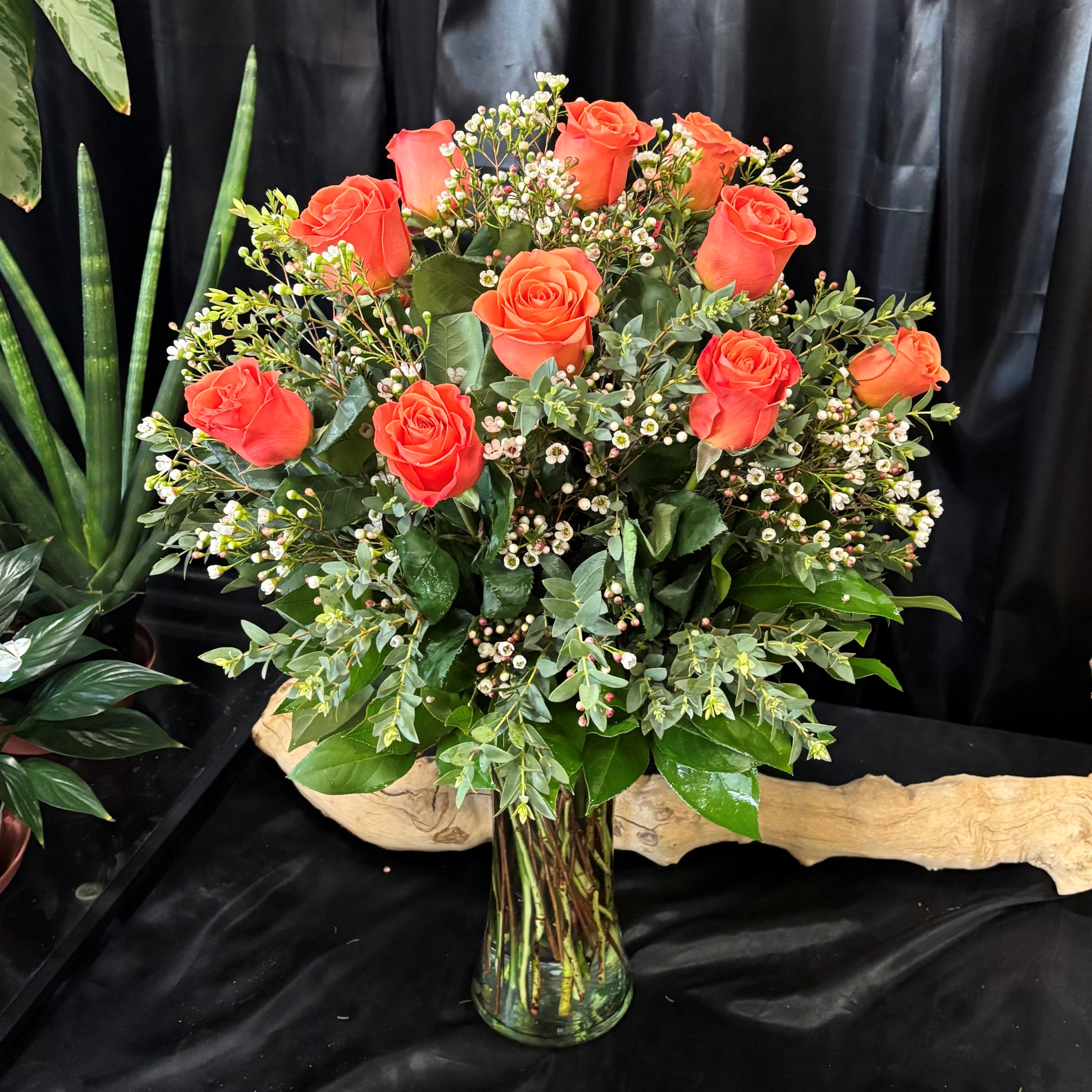 1 Dozen Orange Long Stem Roses - 1 dozen orange roses in a glass vase with premium greens and filler