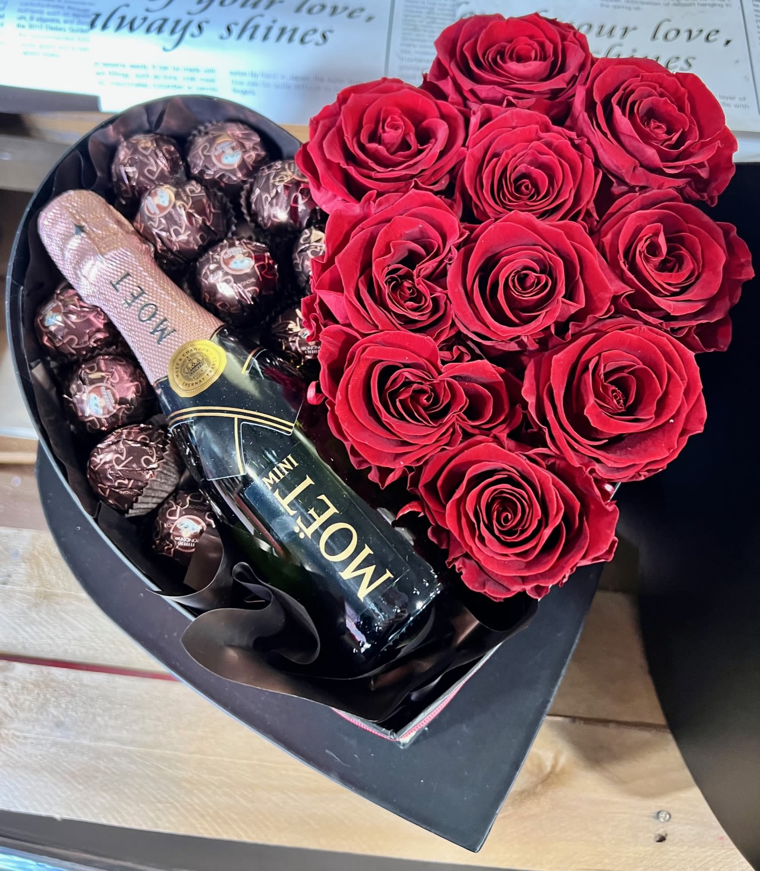 Heart-shaped box with red roses, chocolates, and a mini Moet bottle