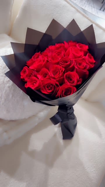 “Crimson Passion Bouquet” - Classic red roses wrapped in black for a bold and romantic statement of love. The Crimson Passion Bouquet is the ultimate symbol of love and desire. Featuring lush red roses wrapped in sleek matte black paper, this bouquet radiates sophistication and intensity. Whether it’s Valentine’s Day, a birthday, just because or an anniversary, this elegant arrangement speaks the language of passion like no other.  18 roses.