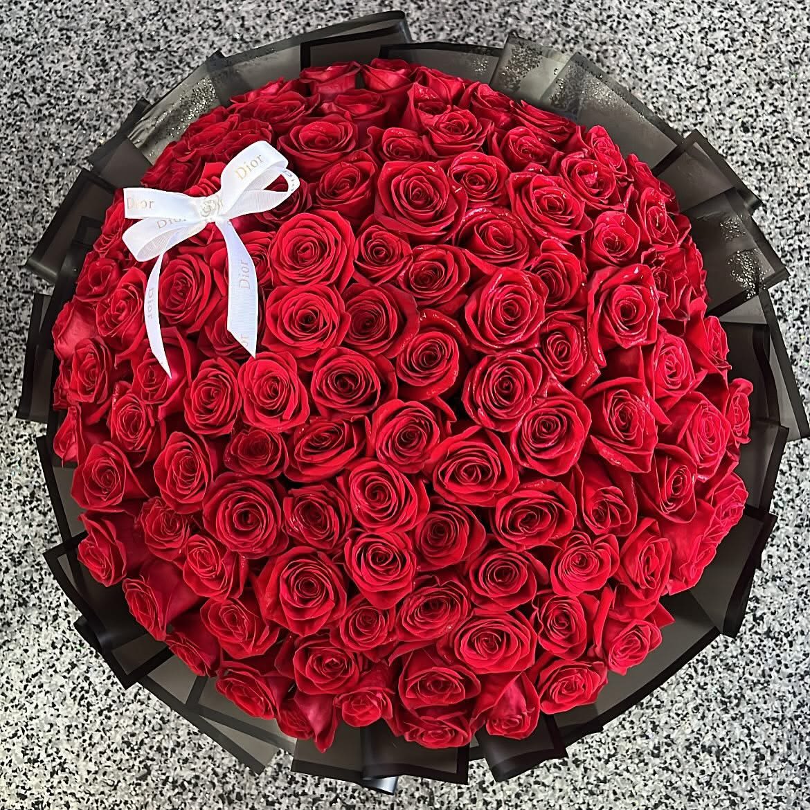 100 Red Rose Bouquet - 100 long-stem fresh red roses wrapped in water proof wrap. Wrap color may vary due to availability. 