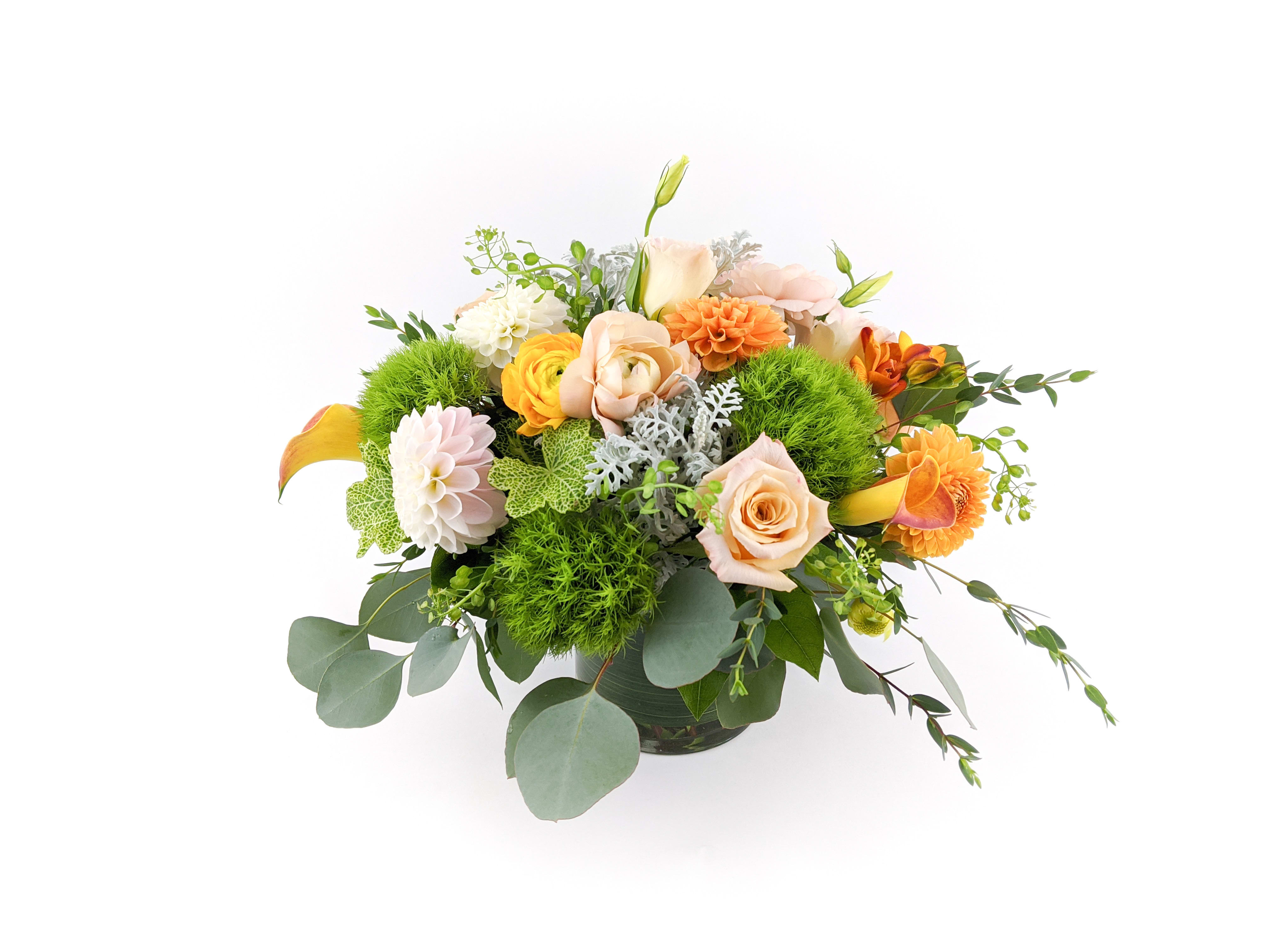 Floral Pastiche - Gorgeous arrangement of dahlias, ranunculus, calla lilies, and peach roses.