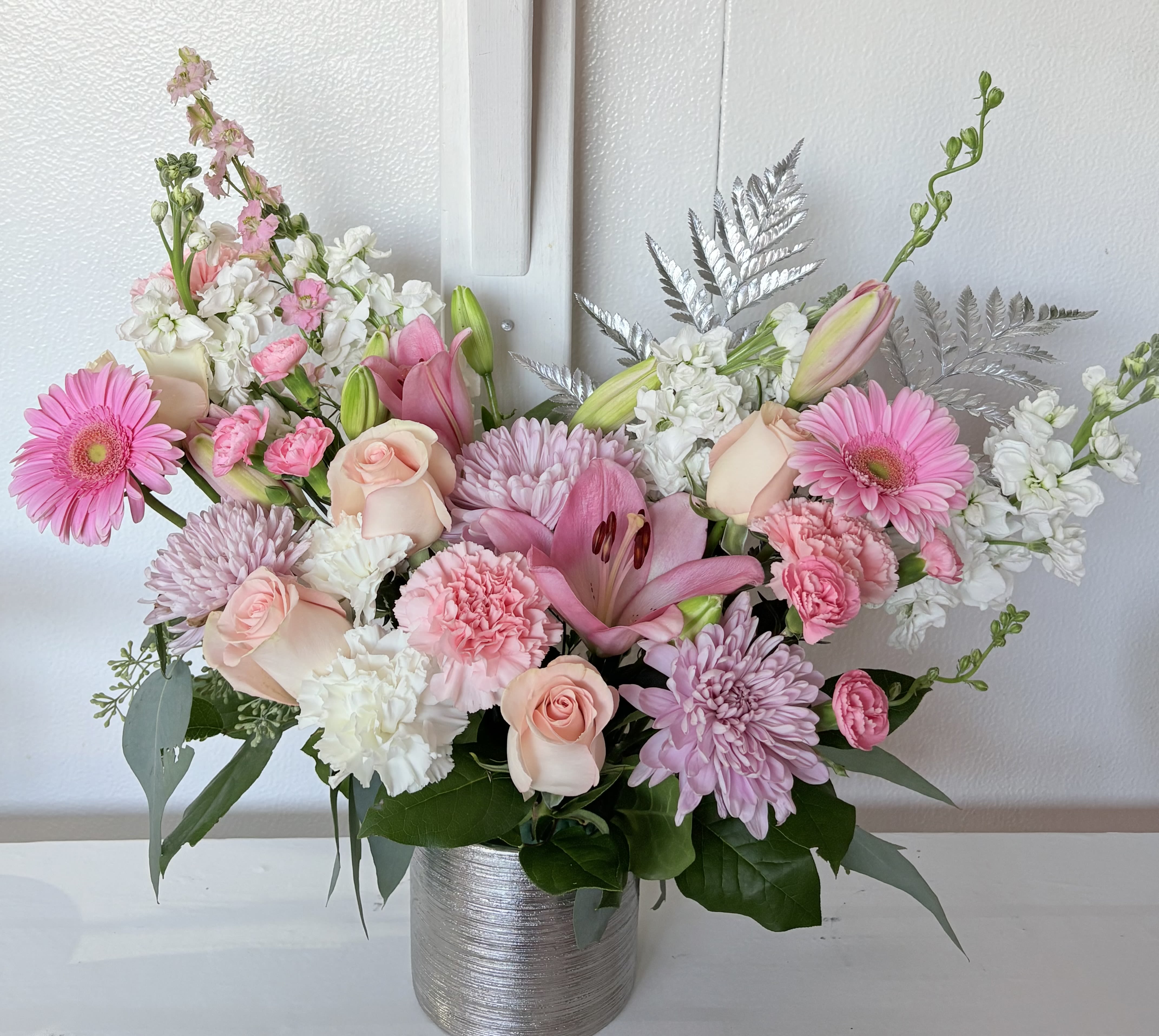 Pretty Garden - Beautiful blush, lavender, and white blooms, in a one sided arrangement. Approximately 17 inches height, 20-24 width. 