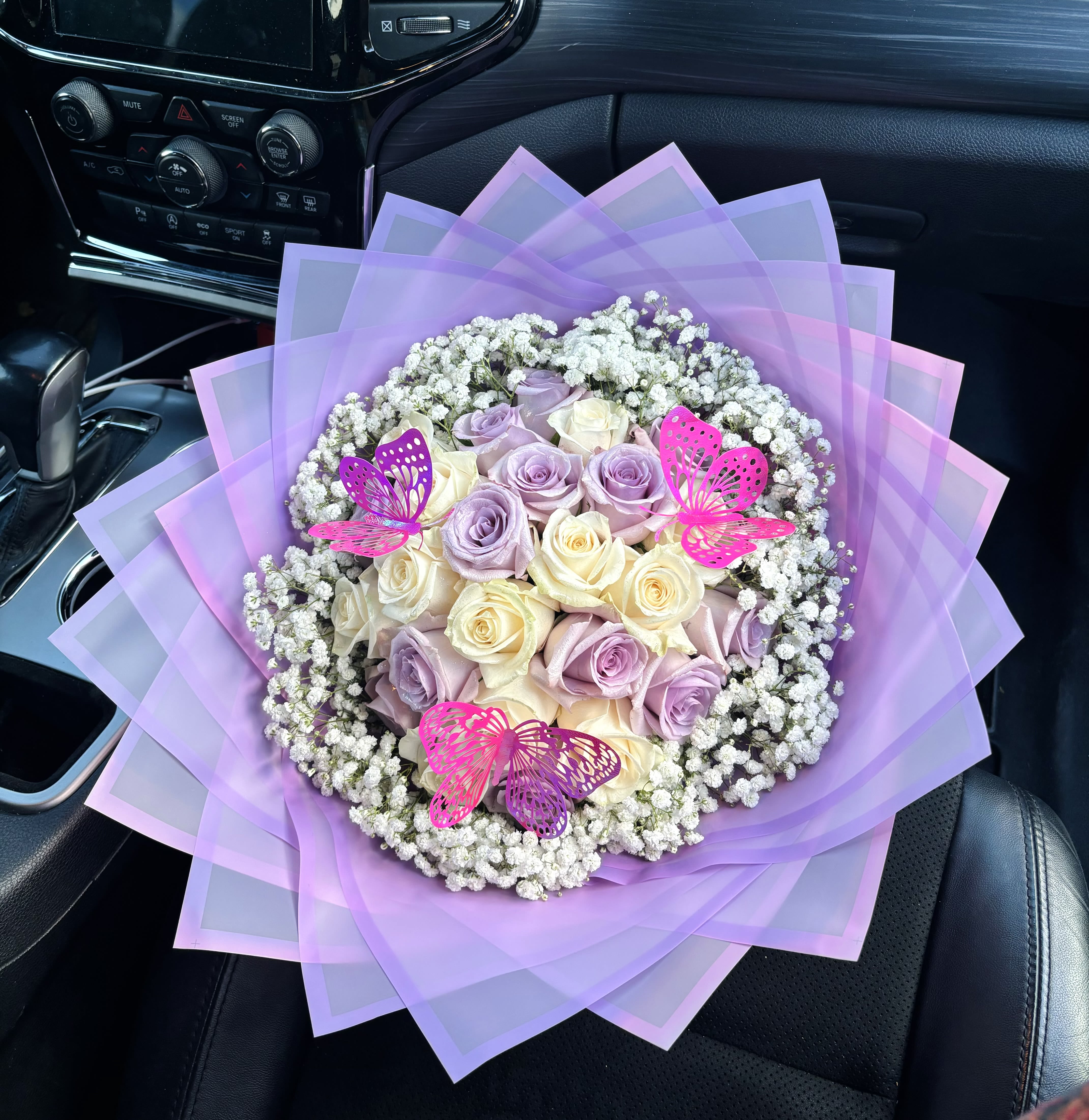 Lavender and cream rose bouquet with baby’s breath and pink butterfly picks