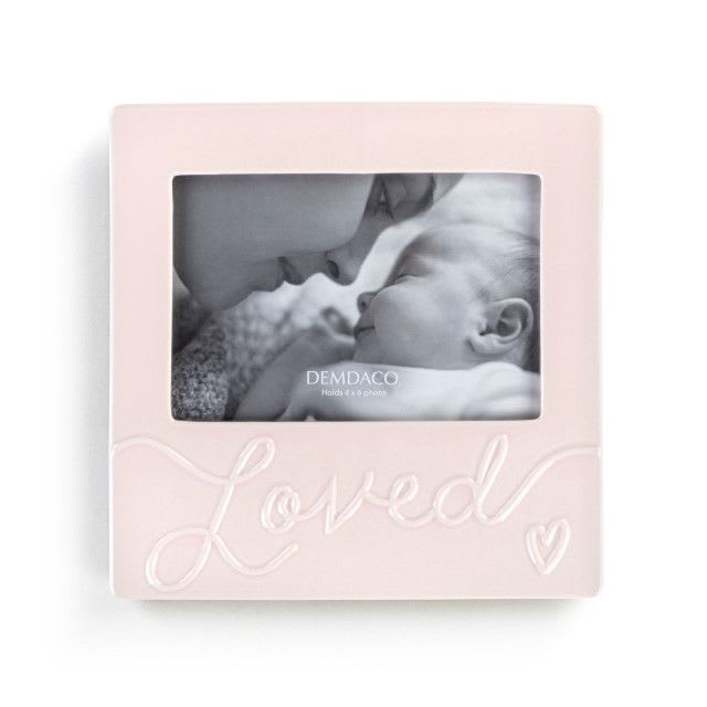 Frame - Loved Baby in Pink - "Luxurious" Collection earned its name by being one of our most lush lines with the most stylish décor for the nursery.  Size: 8"w x .25"d x 8"h Materials: stoneware, glass, paperboard Care Instructions: Not a Toy Sentiment: Loved Backer Style: easel