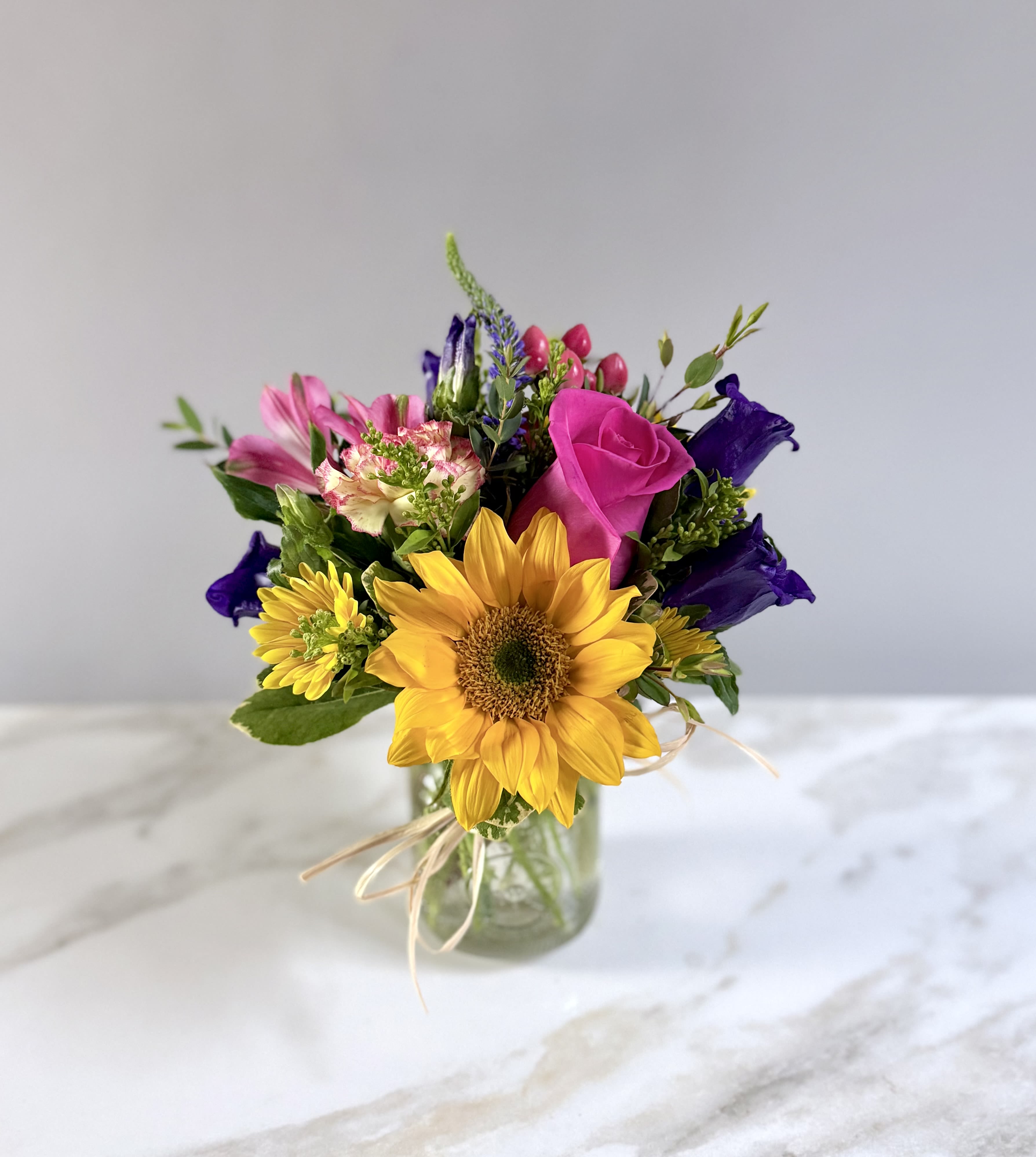 Bright Seasonal Mix- size small  - A small jar filled with our weekly bright colored seasonal mix! A sunflower, hot pink rose, companula, yellow daisies and a coral berry. 