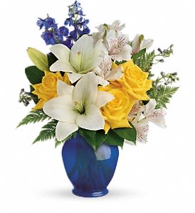 Teleflora's Oceanside Garden Bouquet -  Like a sunny day at the shore, this bright bouquet invigorates and inspires! Radiant yellow roses, white lilies and blue delphinium are expertly arranged in our bold blue plastic ginger jar.      Sunny yellow roses, white asiatic lilies, white alstroemeria, and blue delphinium are arranged with leatherleaf fern and lemon leaf.     Delivered in Teleflora's blue plastic Ginger Jar.     Orientation: All-Around   SUBSTITUTION POLICY – Always deliver the freshest flowers! Please note the bouquet pictured reflects our original design.  If the exact flowers or container in this arrangement are not available, our local florists will create a beautiful bouquet with the freshest available flowers.
