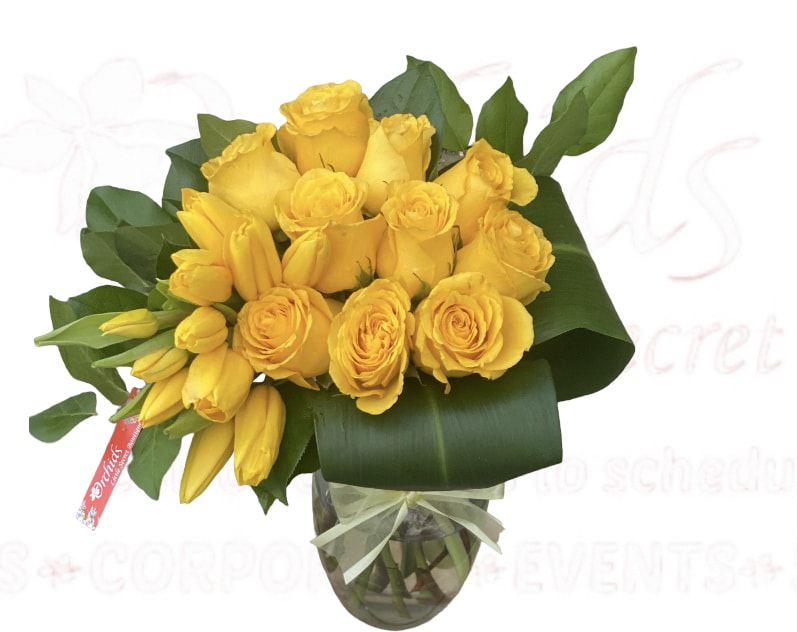 Sunny Delight Tulips &amp; Short Stem Rose Bouquet - Like a ray of morning sunshine, brighten your special recipient's day with sunny yellow tulips and short stem roses presented in a classic 8” clear glass vase, this floral bouquet is a beautiful way to celebrate any of life's special moments. Perfect for  home decor, hotel, restaurant , bathroom vanity, coffee table or office.  Arrangement measures approximately 15"H 