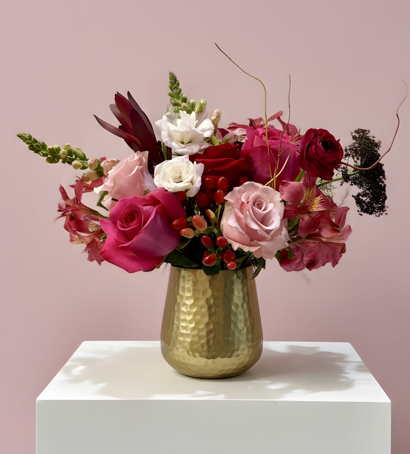 Pink Sugar - A delicious blend of hot pink, light pink, and blush blooms arranged in a radiant gold vase. Flirty, vibrant, and full of charm, this design brings sweetness and style to any celebration or heartfelt gesture.