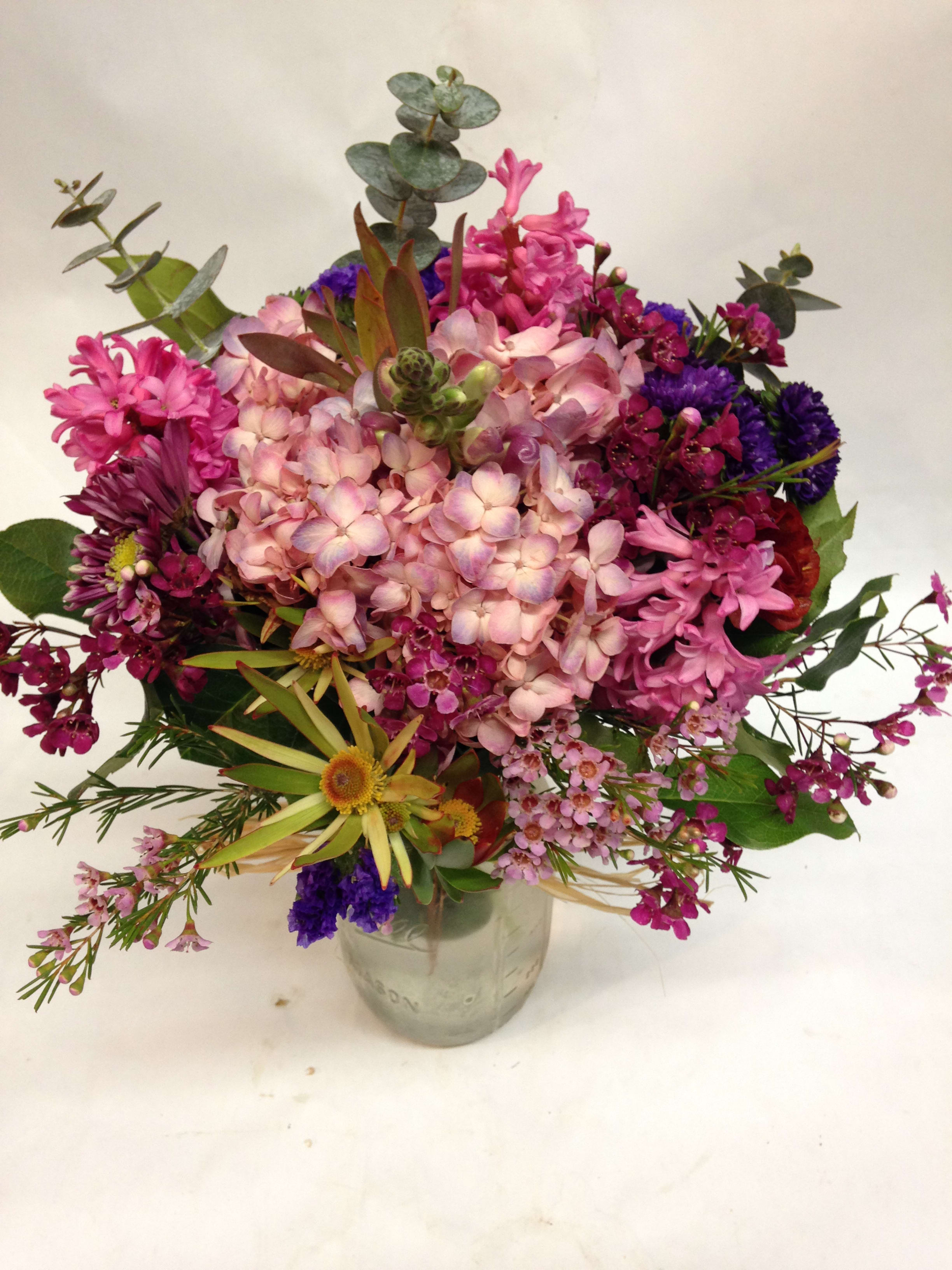 Fabulously Fragrant Jar - A beautiful and fragrant mix of stock      , eucalyptus, hydrangea and more! (Some flowers may be subject to change depending on the season. We will contact you with available flower substitutions; please contact us with specific questions if you are concerned with flower availability, thanks!)  Featured Arrangement: $78.99 (Regular Price)