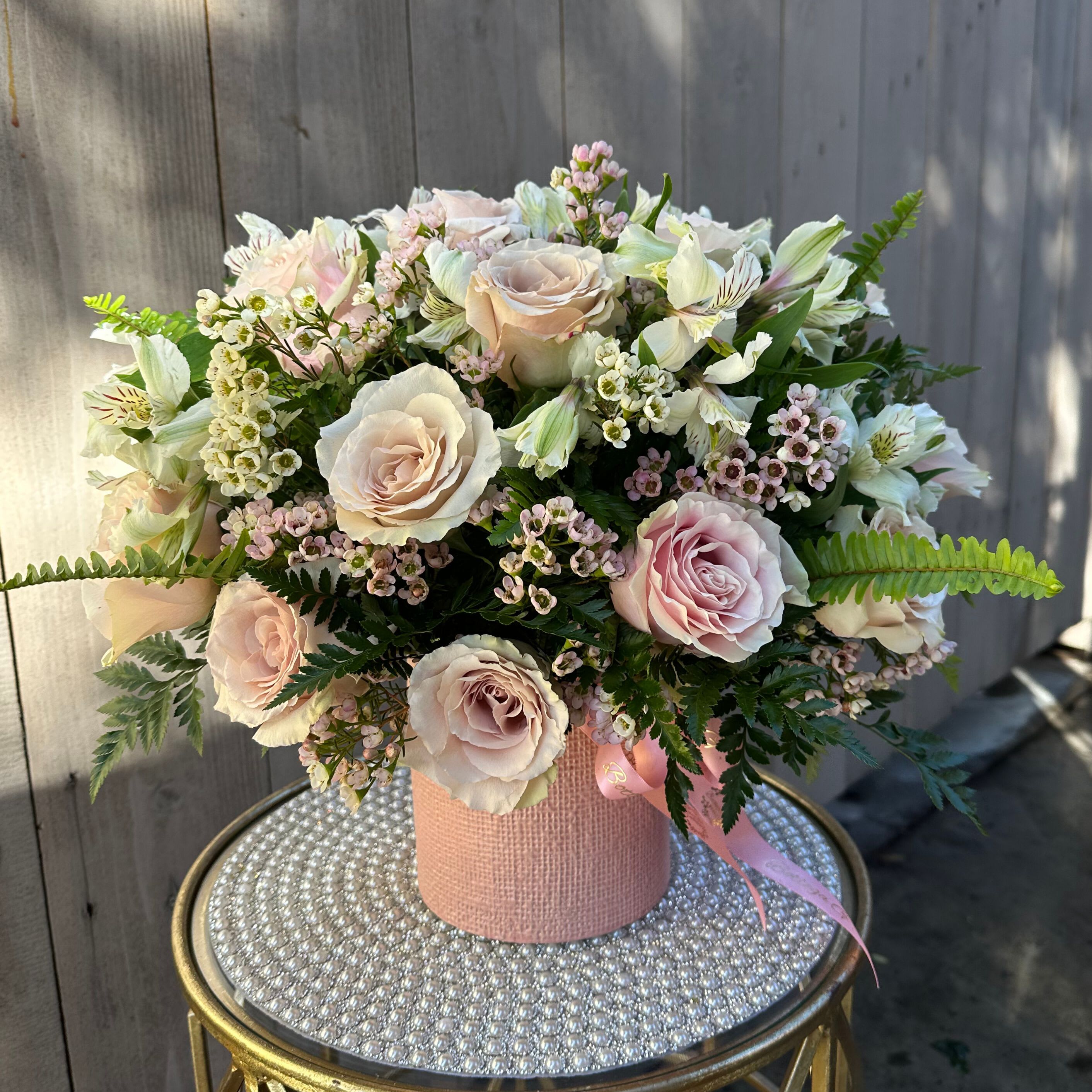 Pink Pop - A sweet and romantic display of soft pink roses, thoughtfully arranged in a matching pink vase. Each rose is carefully selected for its lush petals and delicate hue, creating a monochromatic palette that feels both fresh and timeless. 