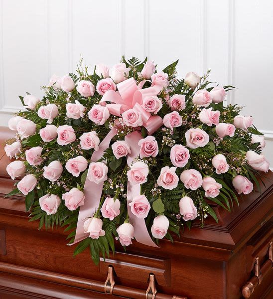 Rose Half Casket In Pink  - Half casket cover arrangement of pink roses, waxflower and fresh greenery; accented with a pink satin ribbon