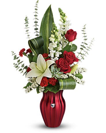  Hearts A flutter Bouquet - A gift with heart! Make their heart flutter this Valentine's Day with a dramatic bouquet of radiant red roses pure white lilies and snapdragons lovingly hand-delivered in a red colored glass vase.