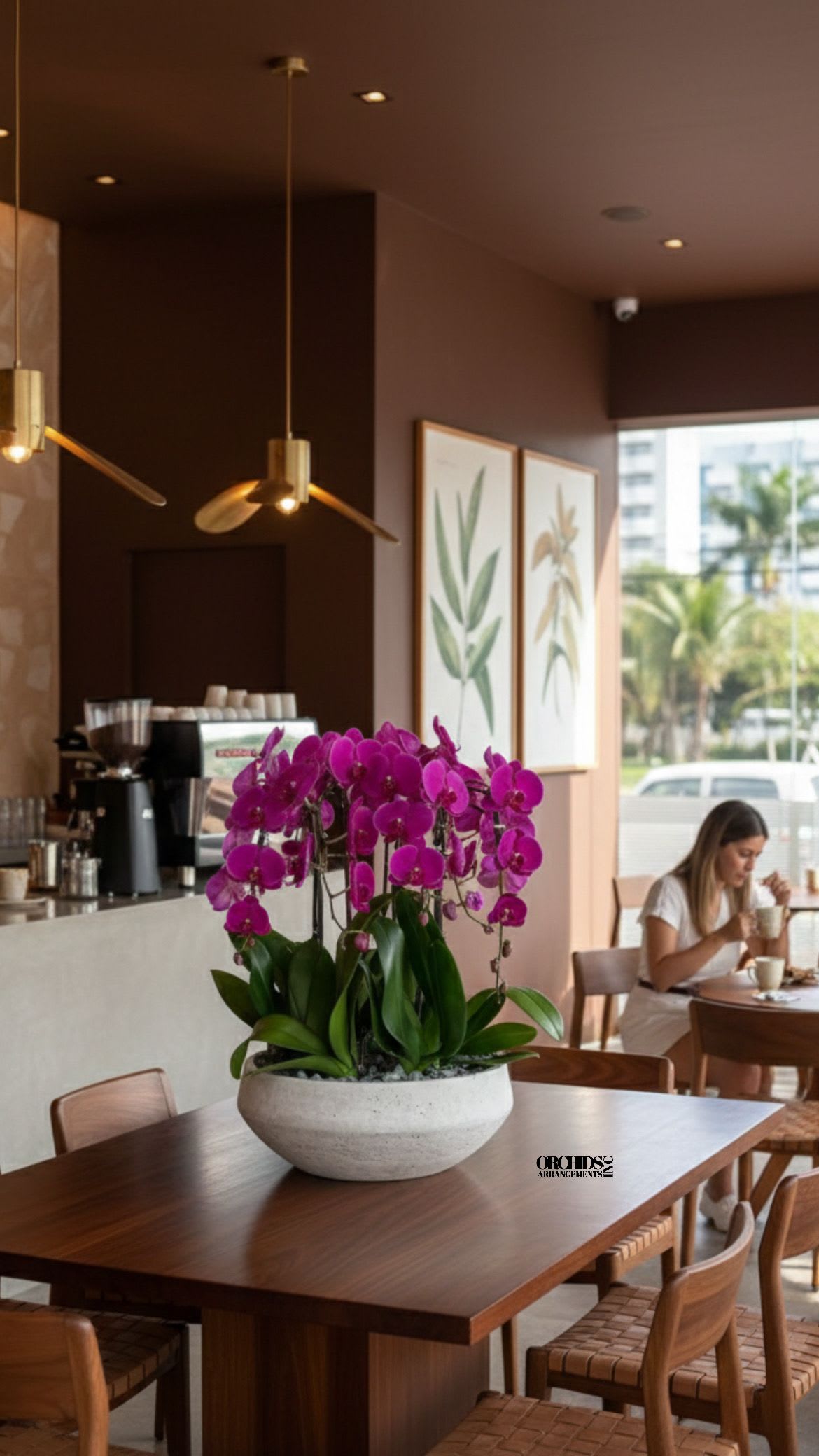 Potted purple orchids in a white bowl on a wooden table