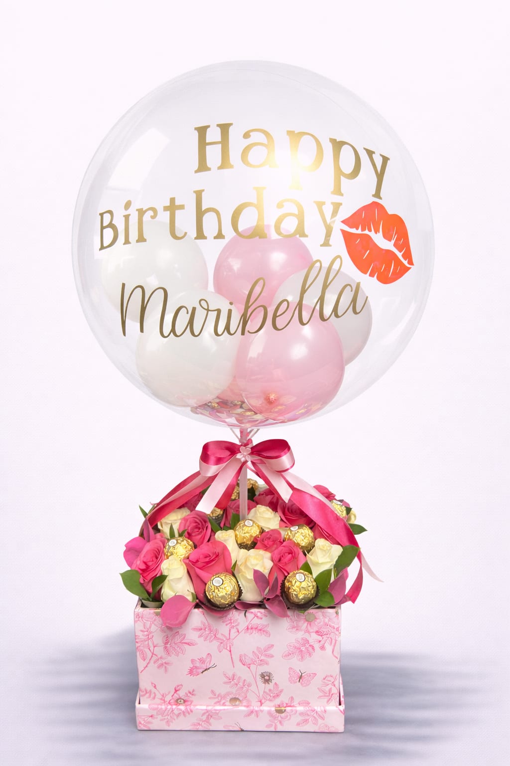 Personalized Princess Celebration - Celebrate her in the most unforgettable way with this luxurious personalized bubble balloon and floral gift. A stunning custom bubble balloon, personalized with her name and birthday message, floats gracefully above a lush arrangement of pink and ivory roses, accented with premium chocolates and fresh greenery.  The transparent bubble balloon is fully customized, making this design uniquely hers — elegant, glamorous, and filled with thoughtful detail. Soft blush tones paired with gold accents create a gift that feels both sophisticated and heartfelt.  Sweet. Chic. Designed to make her feel extraordinary.  Perfect for birthdays, milestone celebrations, or when you want her to feel like the star of the day.