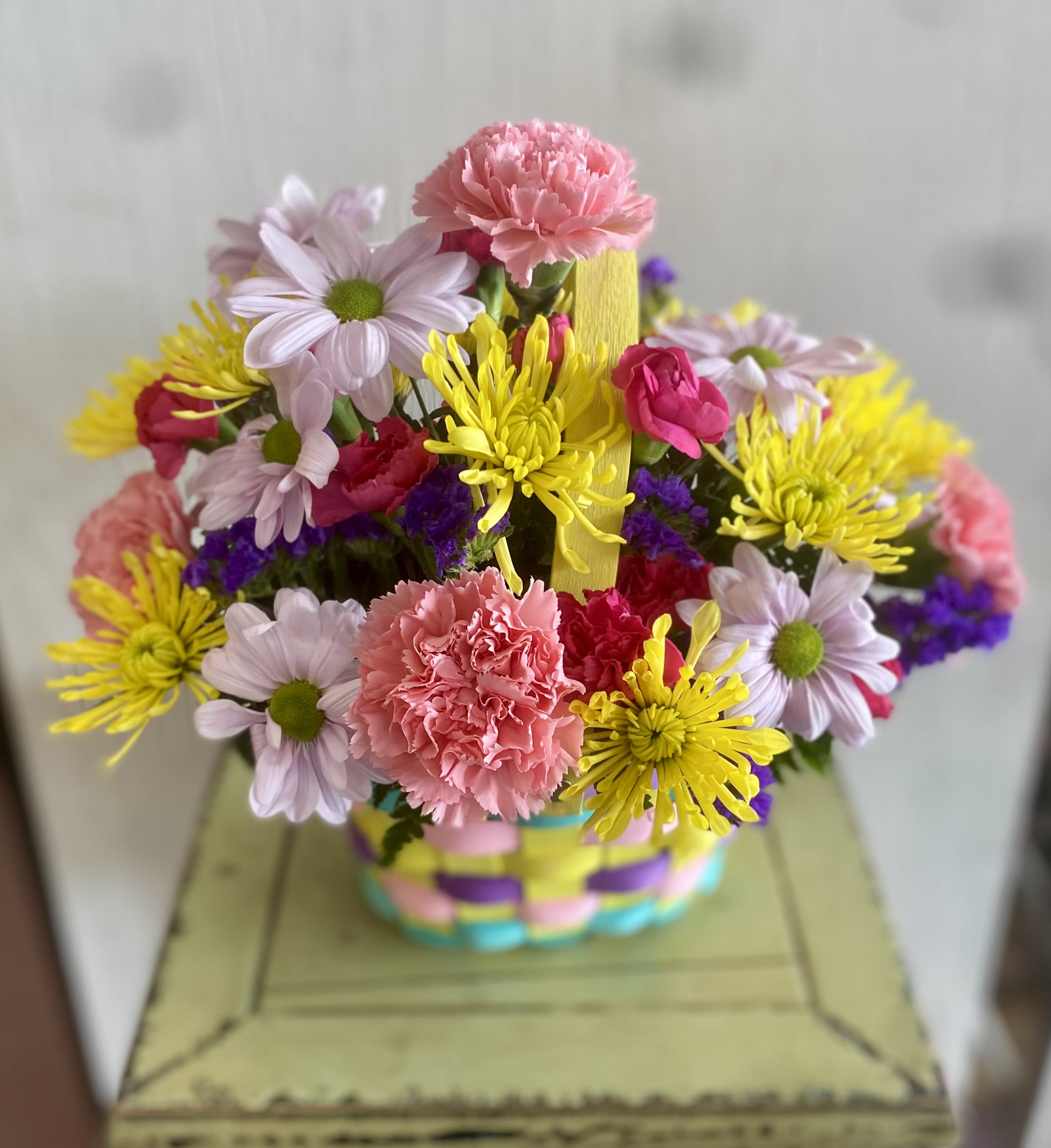 Easter Basket Arrangement - A cheerful basket filled with cheery blooms!