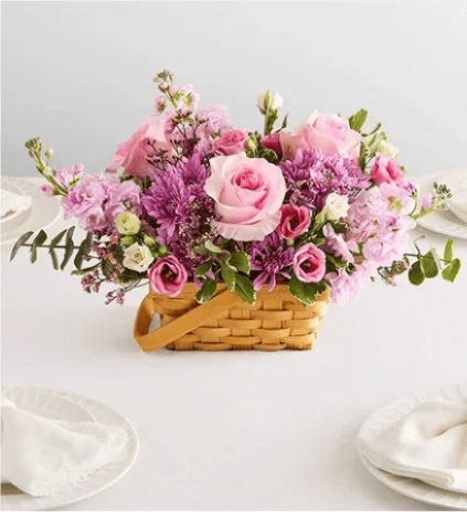 Gathered Abundance - Both bountiful and beautiful, this centerpiece arrangement will brighten the table at any gathering. Welcoming blooms are gracefully designed in a woven basket for fresh-from-the-garden charm.