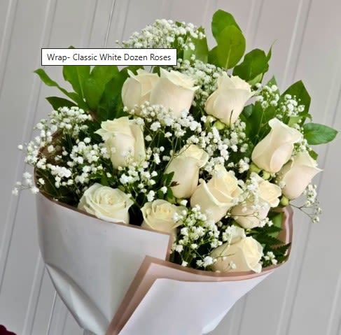 Bouquet of white roses with baby's breath wrapped in white paper