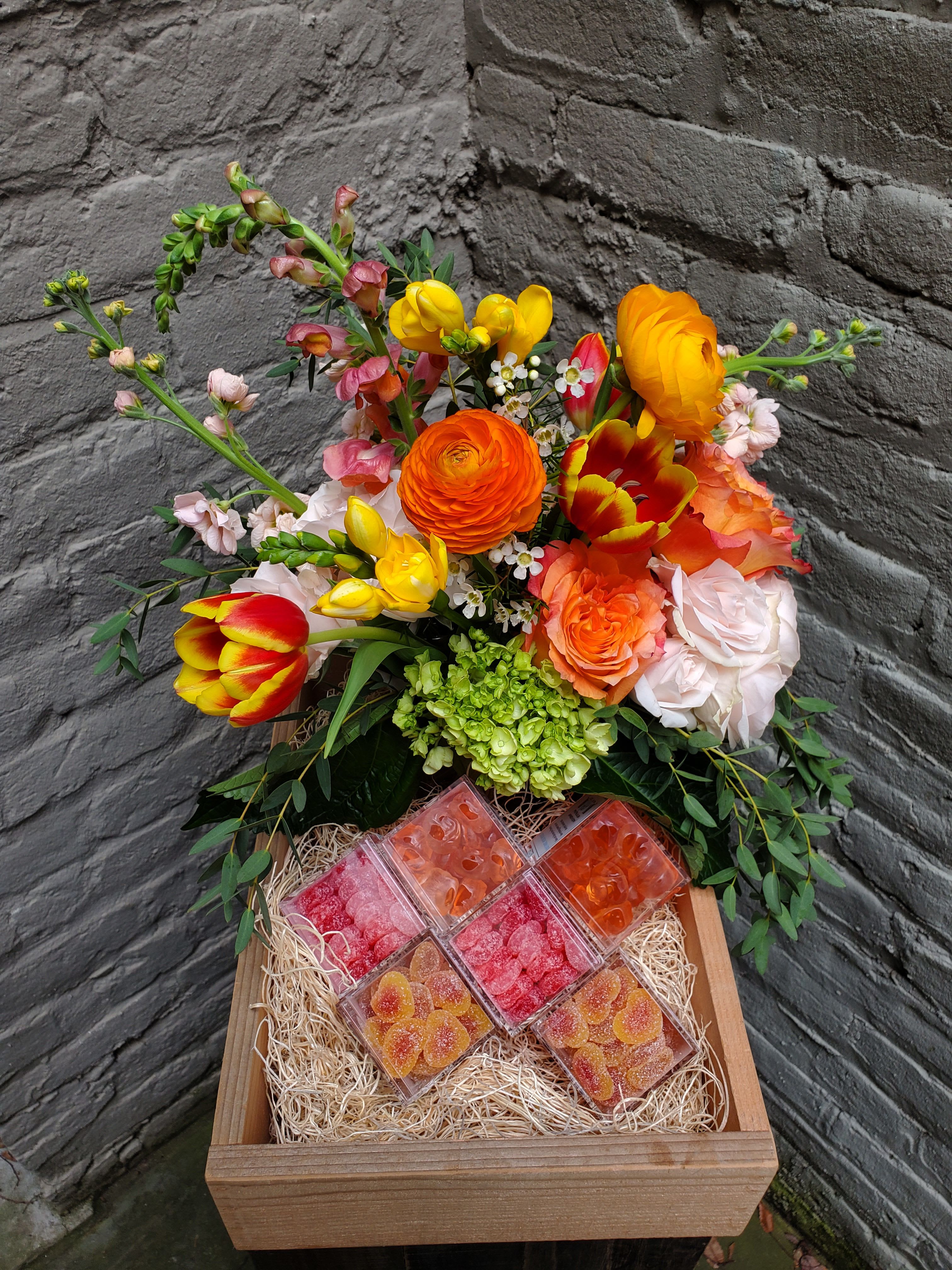 Sweet on You Candy Box - Sweets for your sweets! A lush flower arrangement -- including roses, ranunculus, snapdragons and Virginia tulips -- along with six Sugarfina gummy candy boxes nestled in a locally hand-crafted reclaimed wooden box.    Candy variety options include Strawberry Hearts, Champagne Bears, Rosé Roses, Bourbon Bears, Bubbly Bears, Peach Bellini Hearts, Sparkling Stars, Sour Rainbows, and Baby Butterflies. Choose your own, or allow us to hand-select from our shelves.  Upgrade your box for added sweets and smiles.  