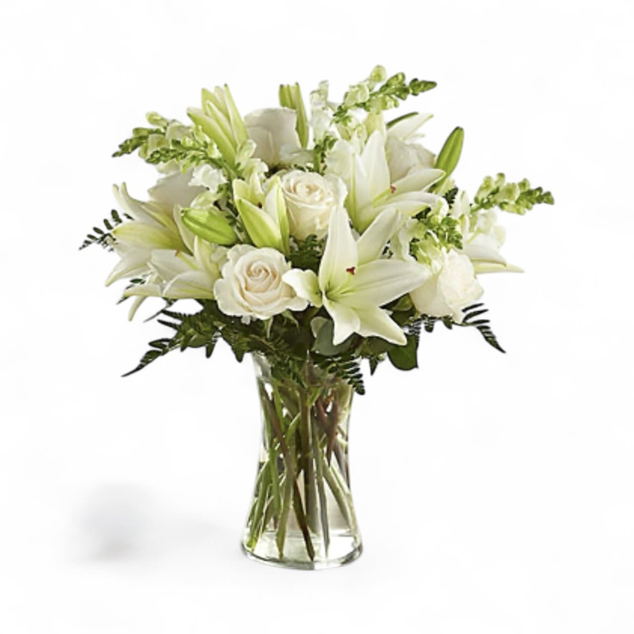 White Wishes - This arrangement symbolizes peace and purity with it's white lilies, snap dragons, and white roses. It is the perfect arrangement for baptism, sympathy or for that person who loves the pureness of white. At times some flowers may be out of stock and not able to be ordered until the following week. In that case, we will substitute flowers only when necessary while keeping the overall look of the arrangement as best as we can. 