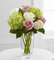 Embracing Grace - The Embracing Grace Bouquet captures the essence of elegance and beauty with this stunning rose and hydrangea bouquet. Pink roses, white roses and green mini hydrangea are simply brought together to create a sweet and stylish flower arrangement. 