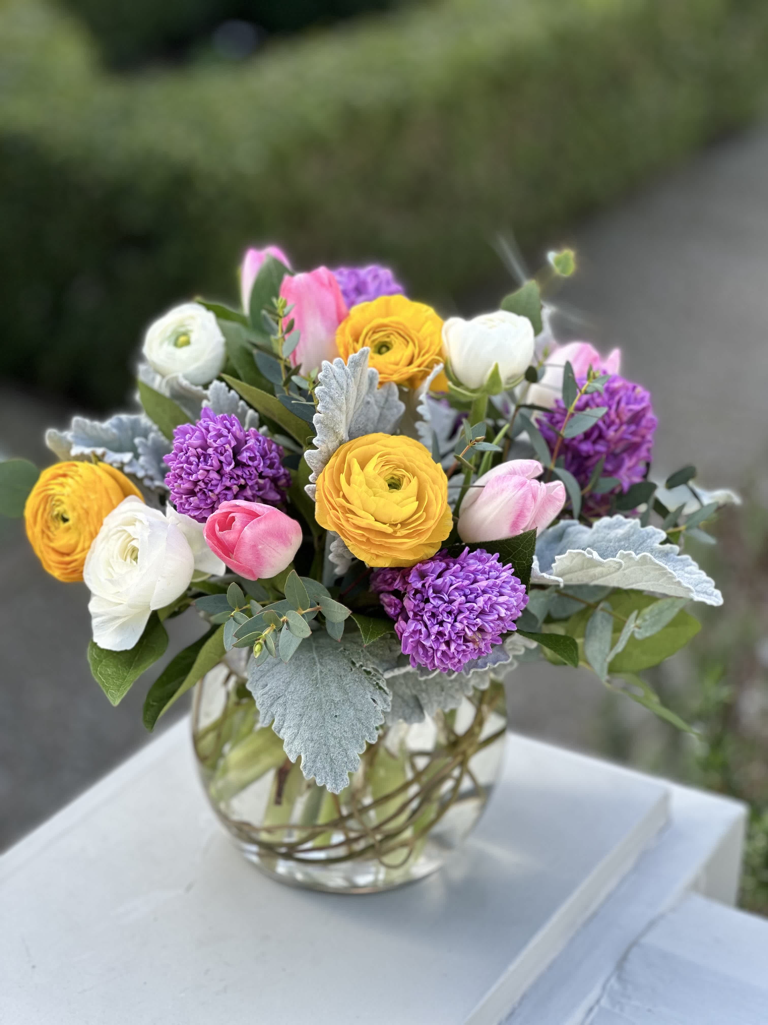 Sweet Spring - Our sweet spring design features fragrant hyacinth, stock, tulip, and ranunculus artfully designed in a bubble bowl with dusty miller and lady's mantle 