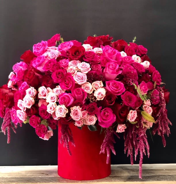 Mixed Flower Box – Red Box - A vibrant arrangement of pink, deep red, and hot pink roses beautifully accented with spray roses, hydrangea, and cascading amaranthus. Designed in an elegant matching box, this lush floral display makes a stunning gift for birthdays, anniversaries, celebrations, or any special occasion.  Note: Flower varieties may vary slightly depending on seasonal availability while maintaining the overall color palette, size, and style   Available: Deluxe  Premium   Holiday Delivery:  Same-day delivery available. Deliveries are made throughout the day based on routing. 